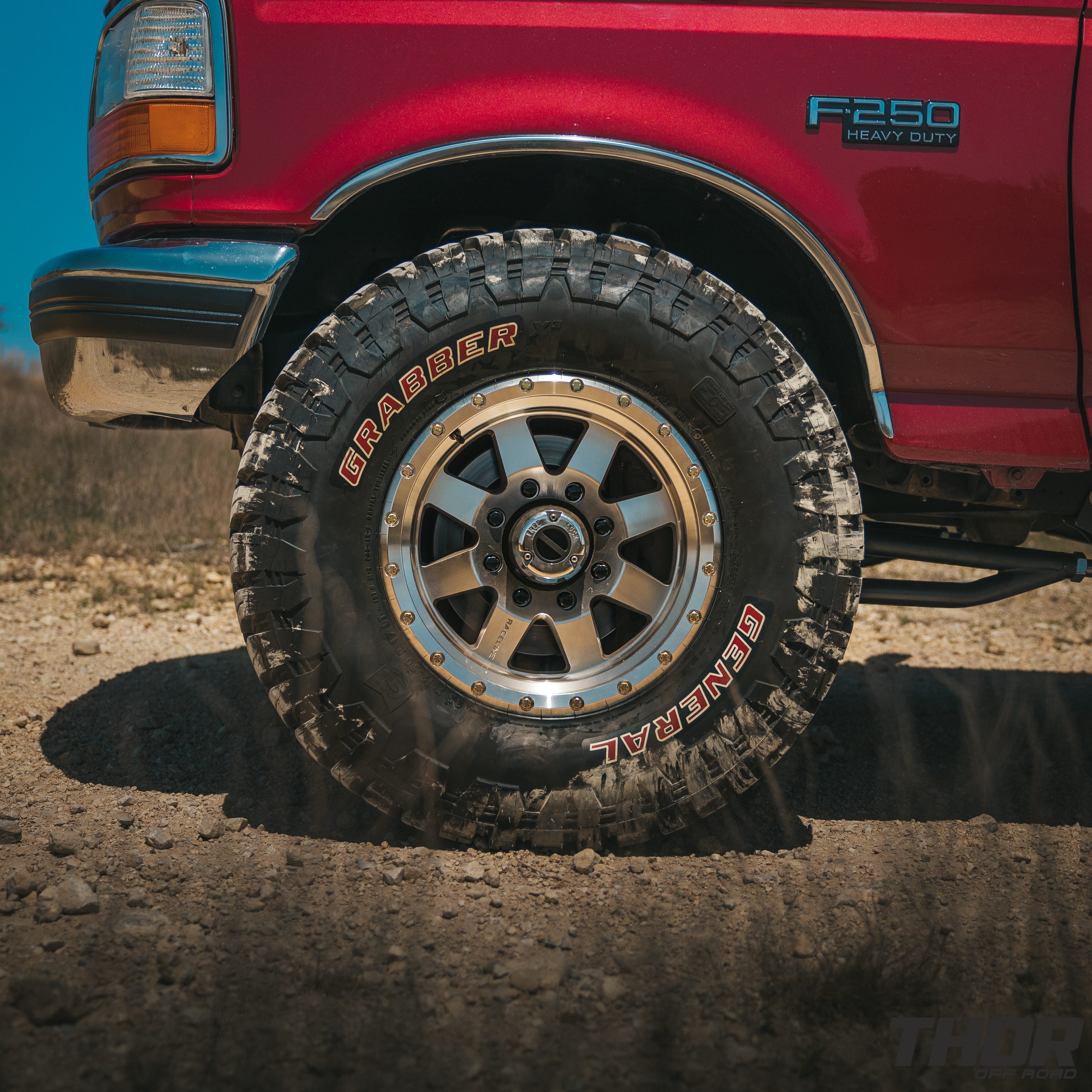 1997 Ford F-250 Super Duty XLT in Red with Bilstein Coil Over Conversion, Rear Leaf Spring Replacement, 17" Raceline Defender Wheels, 35x12.50R17 General Grabber MT Tires