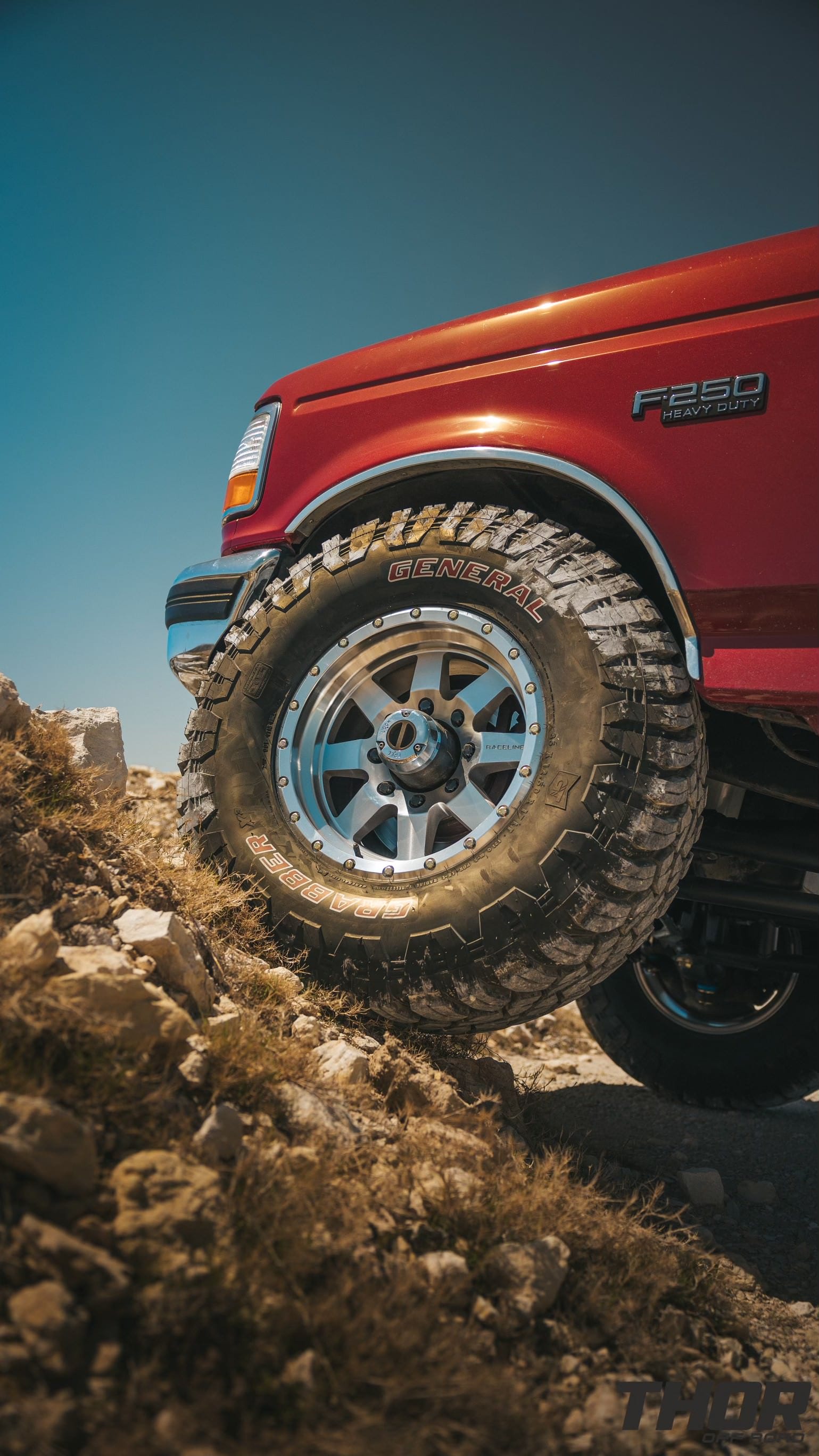 1997 Ford F-250 Super Duty XLT in Red with Bilstein Coil Over Conversion, Rear Leaf Spring Replacement, 17" Raceline Defender Wheels, 35x12.50R17 General Grabber MT Tires