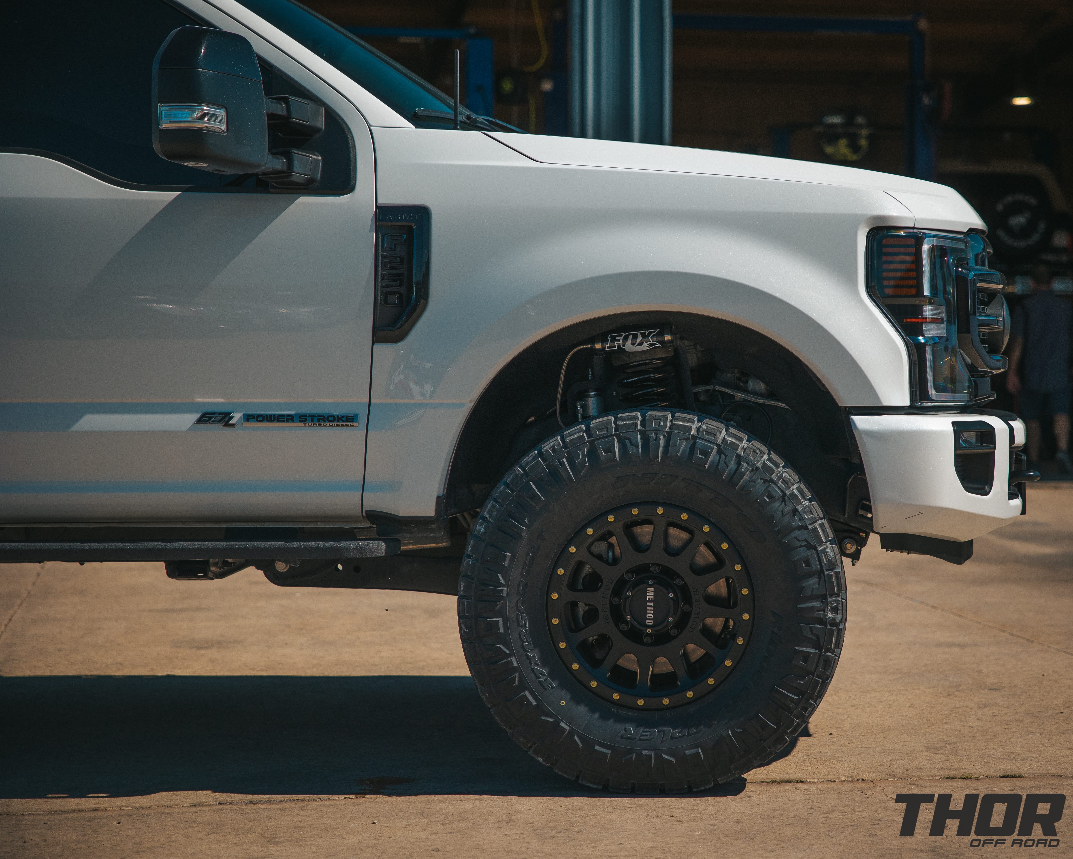 2022 Ford F-250 Super Duty Lariat in White with 3.5" Carli Backcountry Suspension, Carli Full Rear Leaf Springs, 18x9" Method 305NV Wheels, 3712.50R18 Nitto Ridge Grappler Tires