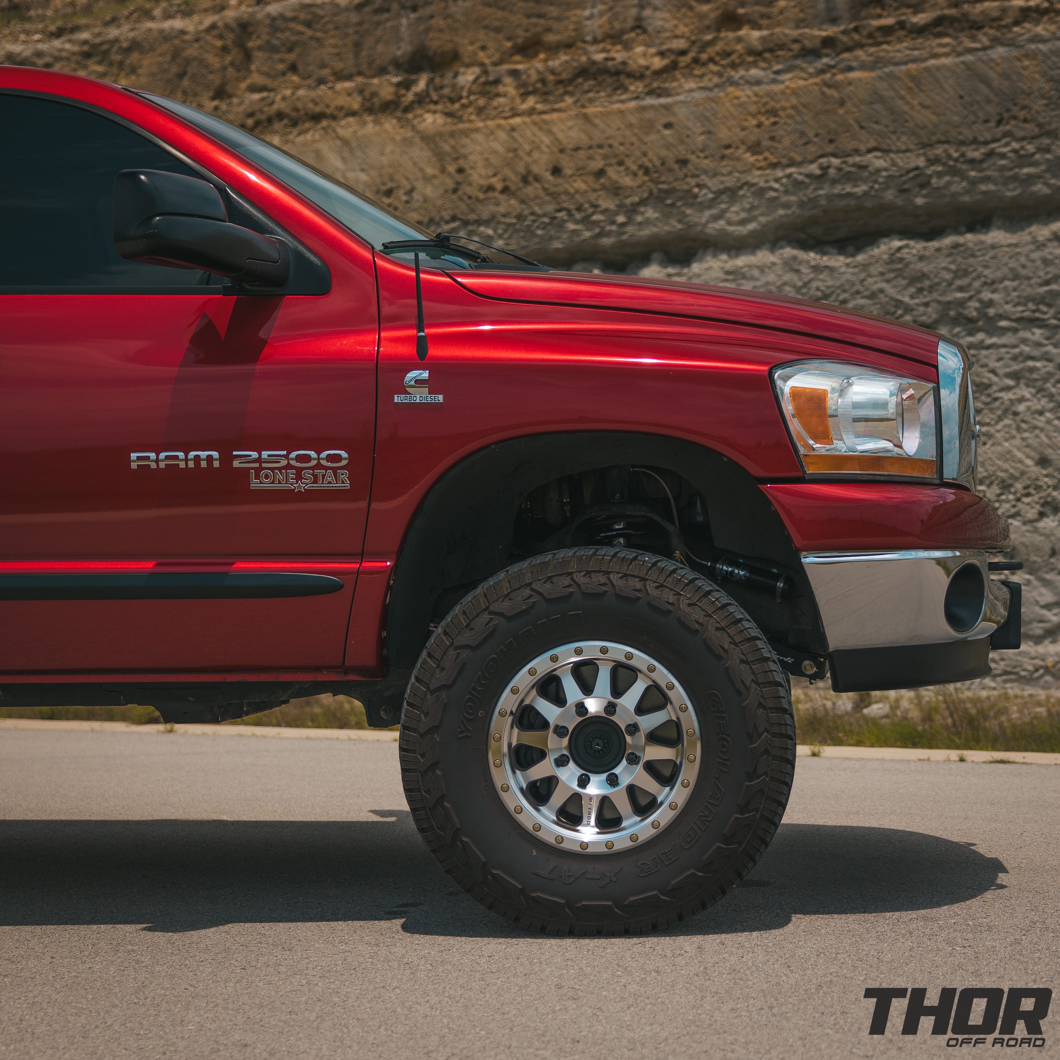 2006 RAM 2500 SLT in Red with Carli 3" Backcountry Suspension, Performance Series 2.0 Reservoir Shocks, Carli Extended Control Arms, Carli Torsion Sway Bar, Carli Full Proggressive Leaf Springs, 17" Method 315 Machined Wheels, 35x12.50R17 Yokohama XAT Tires