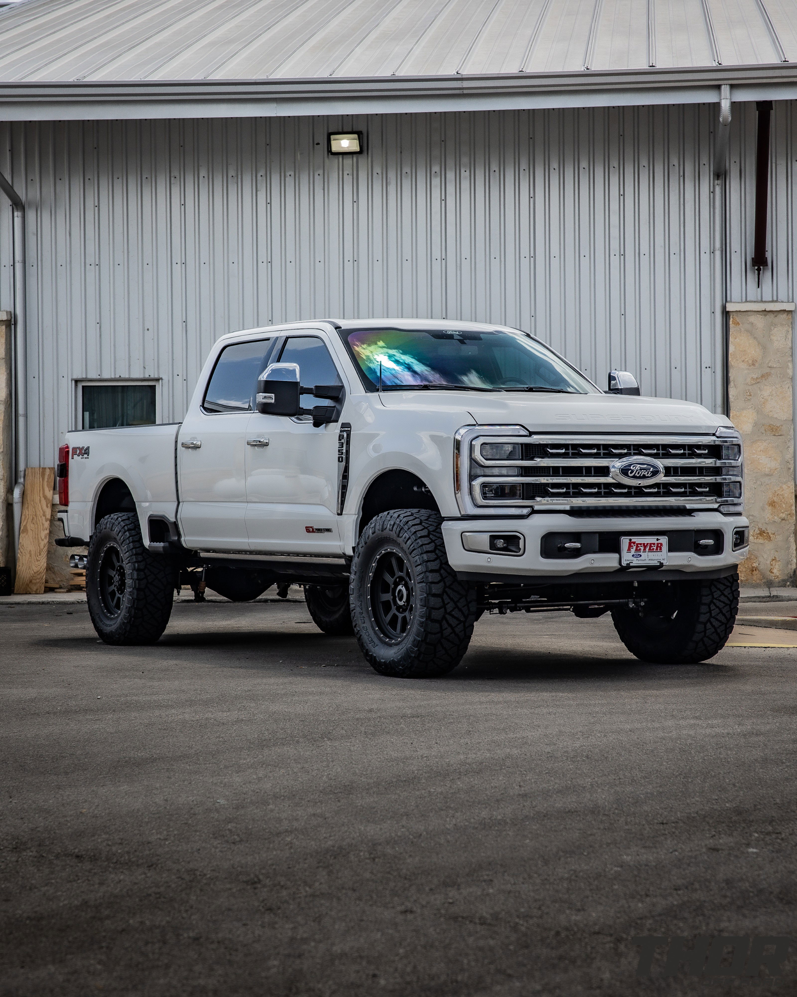 2023 Ford F-250 Super Duty Platinum in White with Carli E-Venture 3.5" Suspension Kit, Carli 3.5" Fabricated Radius Arms, Carli 3.5" Full Rear Spring Replacement, Carli Low Mount Steering Stabilizer, Carli High Mount Steering Stabilizer, Carli Torsion Sway Bar, Carli Trophy Hitch, Full Travel Air Bag Kit, S&B 60 Gallon Fuel Tank, CJC Lockout Bracket, Nitto Ridge Grappler 38x12.50R20 Tires