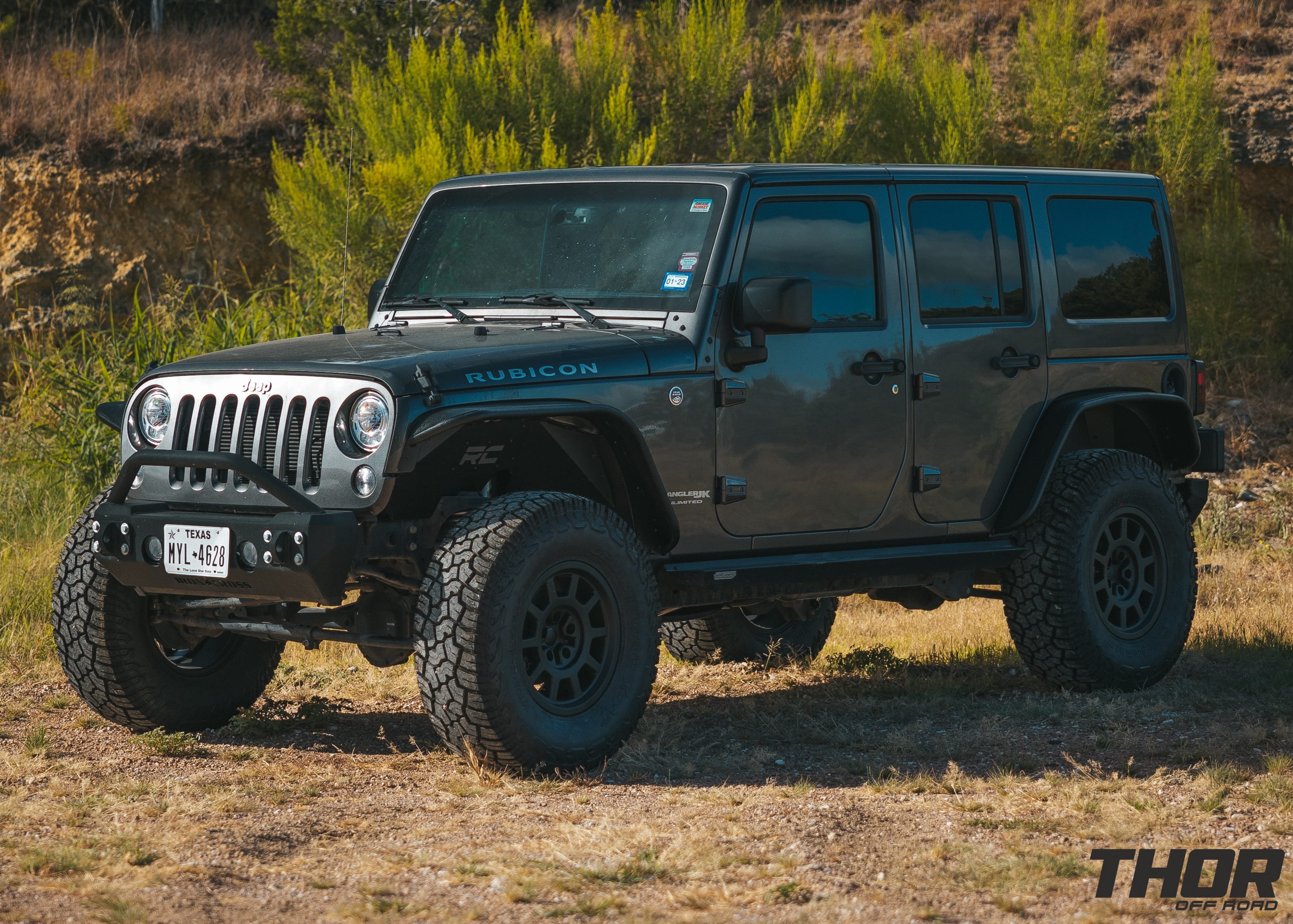 2018 Jeep Wrangler Unlimited Rubicon in Anvil Clearcoat with Rough Country 2.5" V2 Lift Kit, 17x8.5" AEV Salta Matte Black Wheels, 35x12.50R17 Yokohama Geolander X-AT Tires, Fender Flares