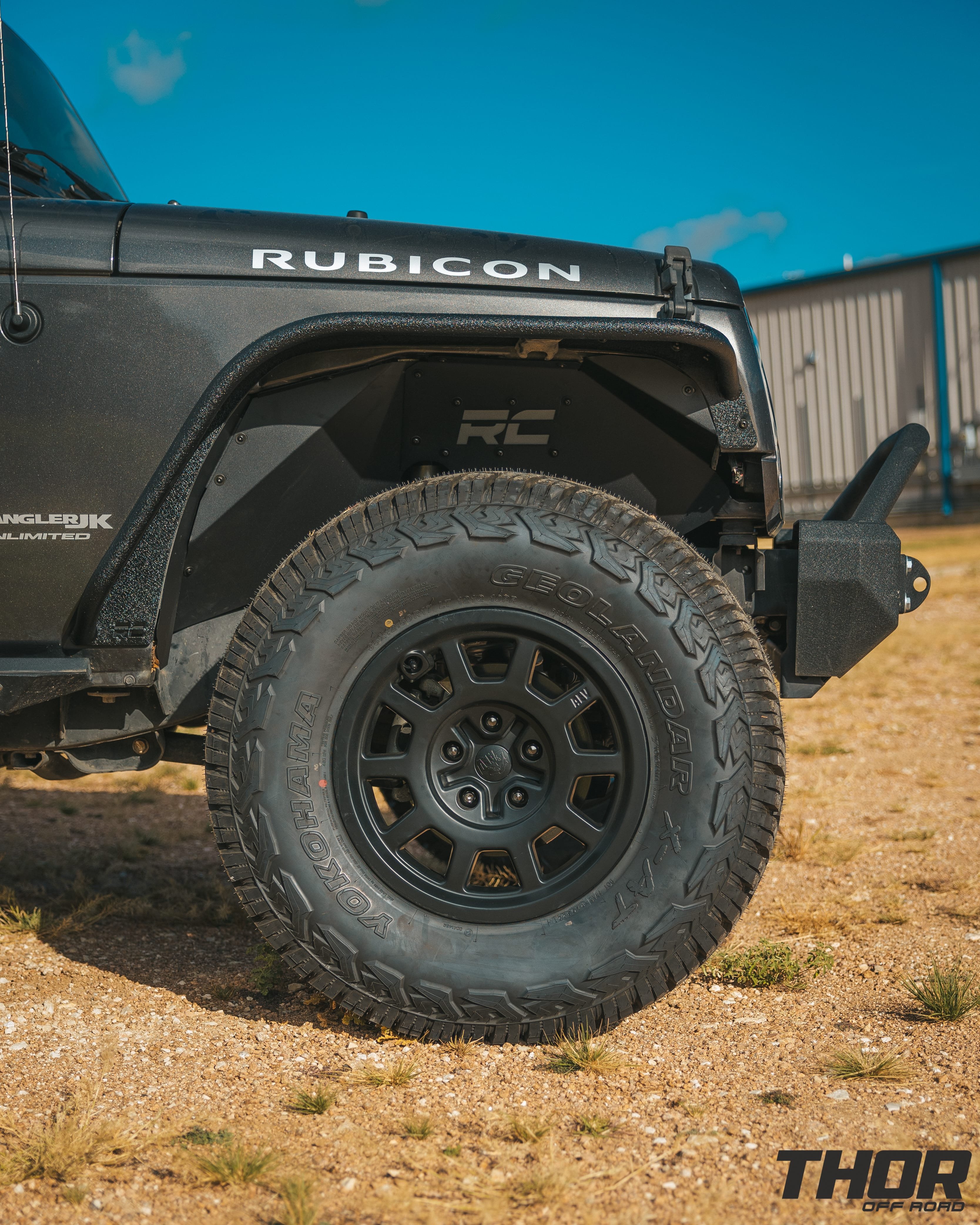 2018 Jeep Wrangler Unlimited Rubicon in Anvil Clearcoat with Rough Country 2.5" V2 Lift Kit, 17x8.5" AEV Salta Matte Black Wheels, 35x12.50R17 Yokohama Geolander X-AT Tires, Fender Flares