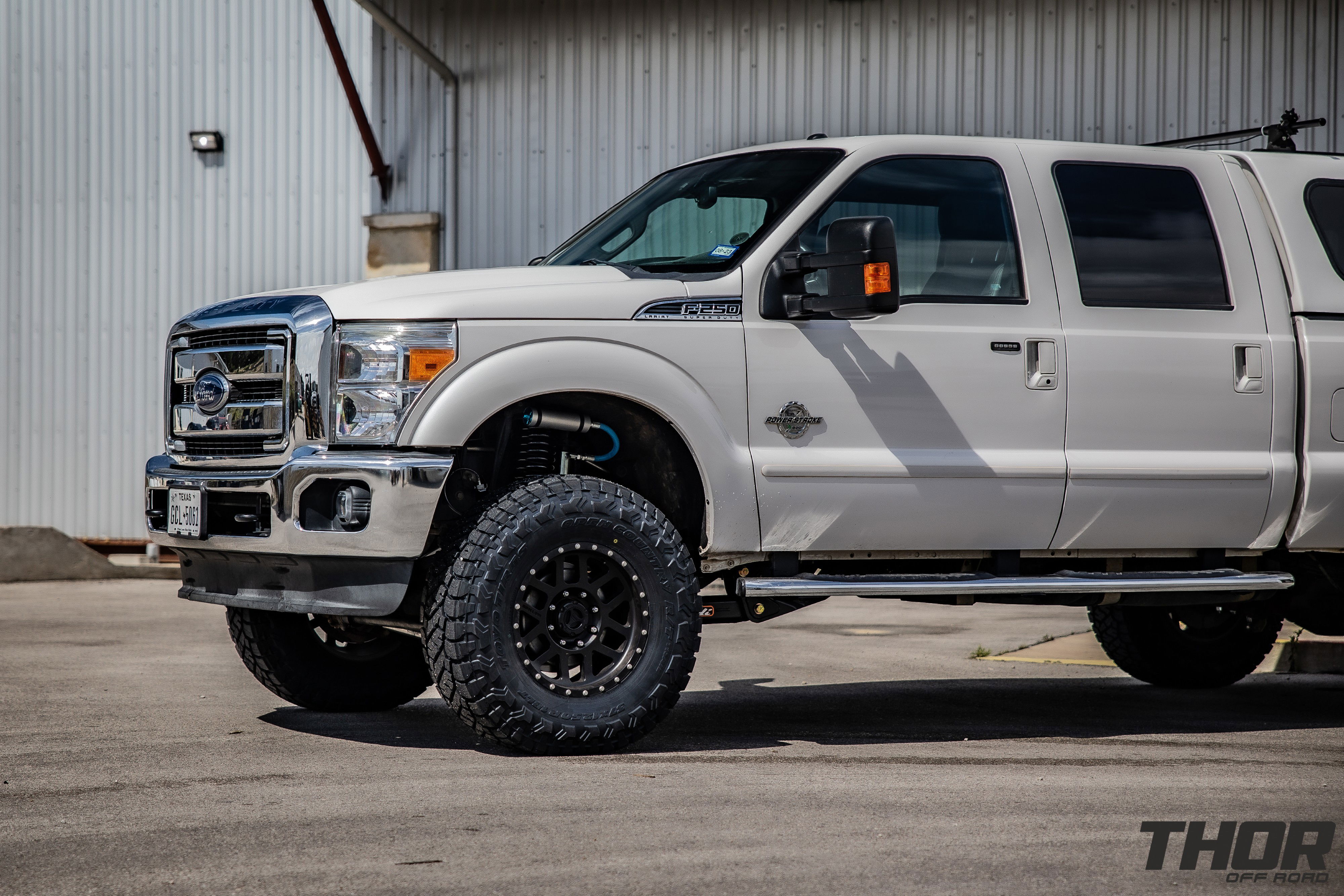 2015 Ford F-250 Super Duty Lariat in White with Carli 5.5" King Pintop Suspension Kit, Carli High Mount Steering Stabilizer, Carli Low Mount Steering Stabilizer, Carli Adjustable Radius Arms, 37x12.50R18 Toyo Open Country R/T Trail Tires