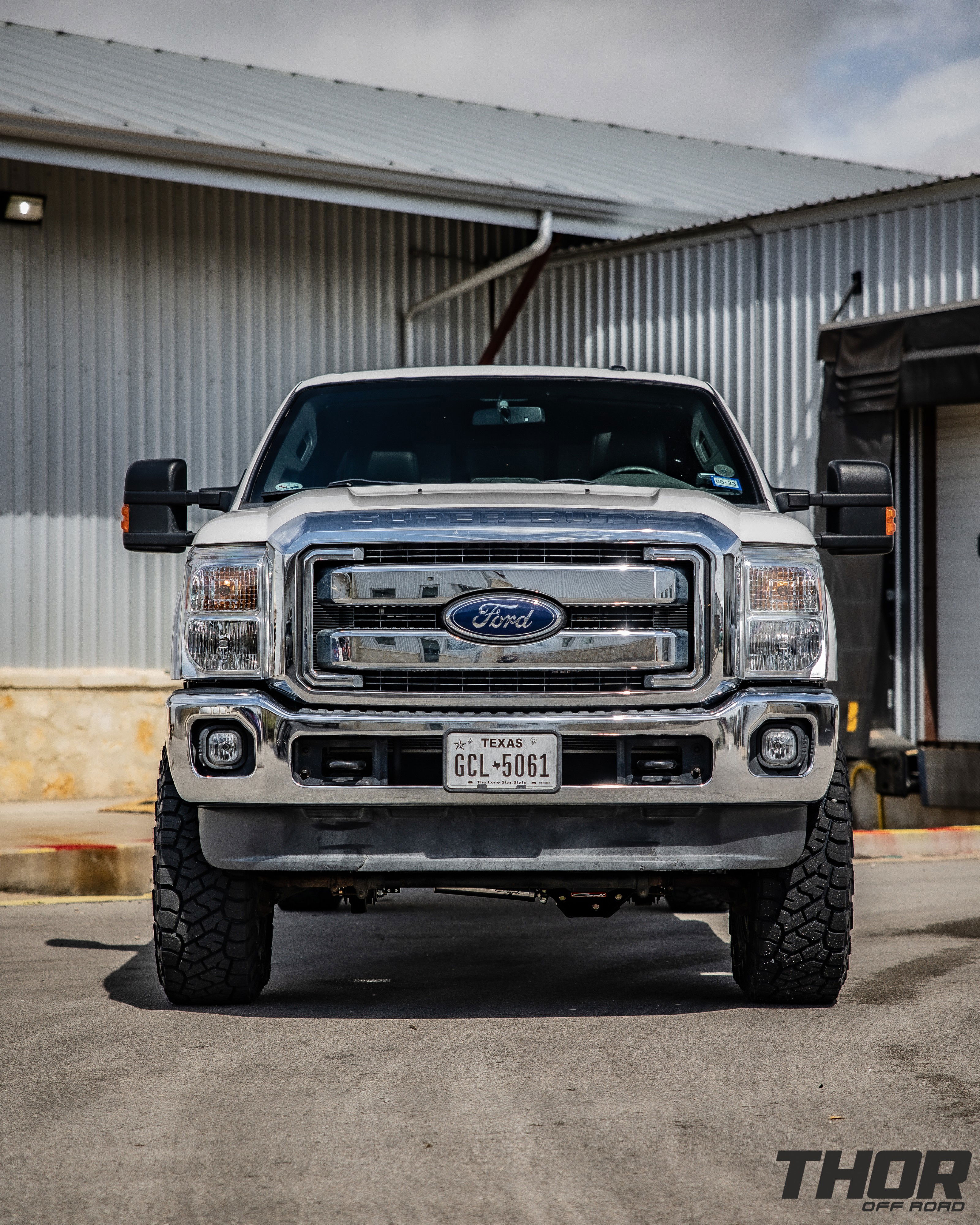 2015 Ford F-250 Super Duty Lariat in White with Carli 5.5" King Pintop Suspension Kit, Carli High Mount Steering Stabilizer, Carli Low Mount Steering Stabilizer, Carli Adjustable Radius Arms, 37x12.50R18 Toyo Open Country R/T Trail Tires