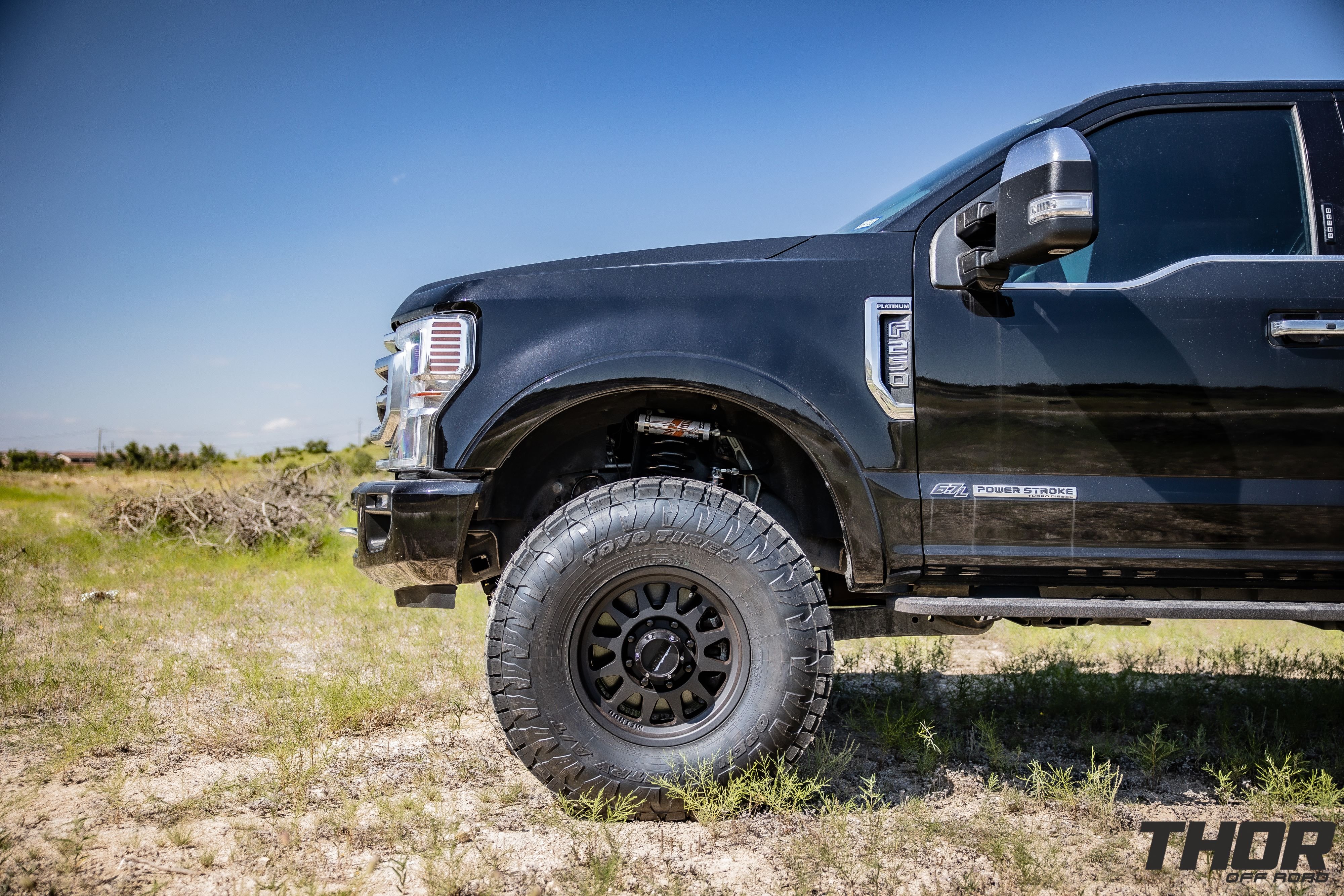 2022 Ford F-250 Super Duty Platinum in Black with Carli Backcountry 3.5" Suspension Kit, Carli High Mount Steering Stabilizer, Carli Torsion Sway Bar, Method MR704 HD 17x9" Bead Grip Wheels, 37x12.50R17 Toyo Open Country A/T III Tires