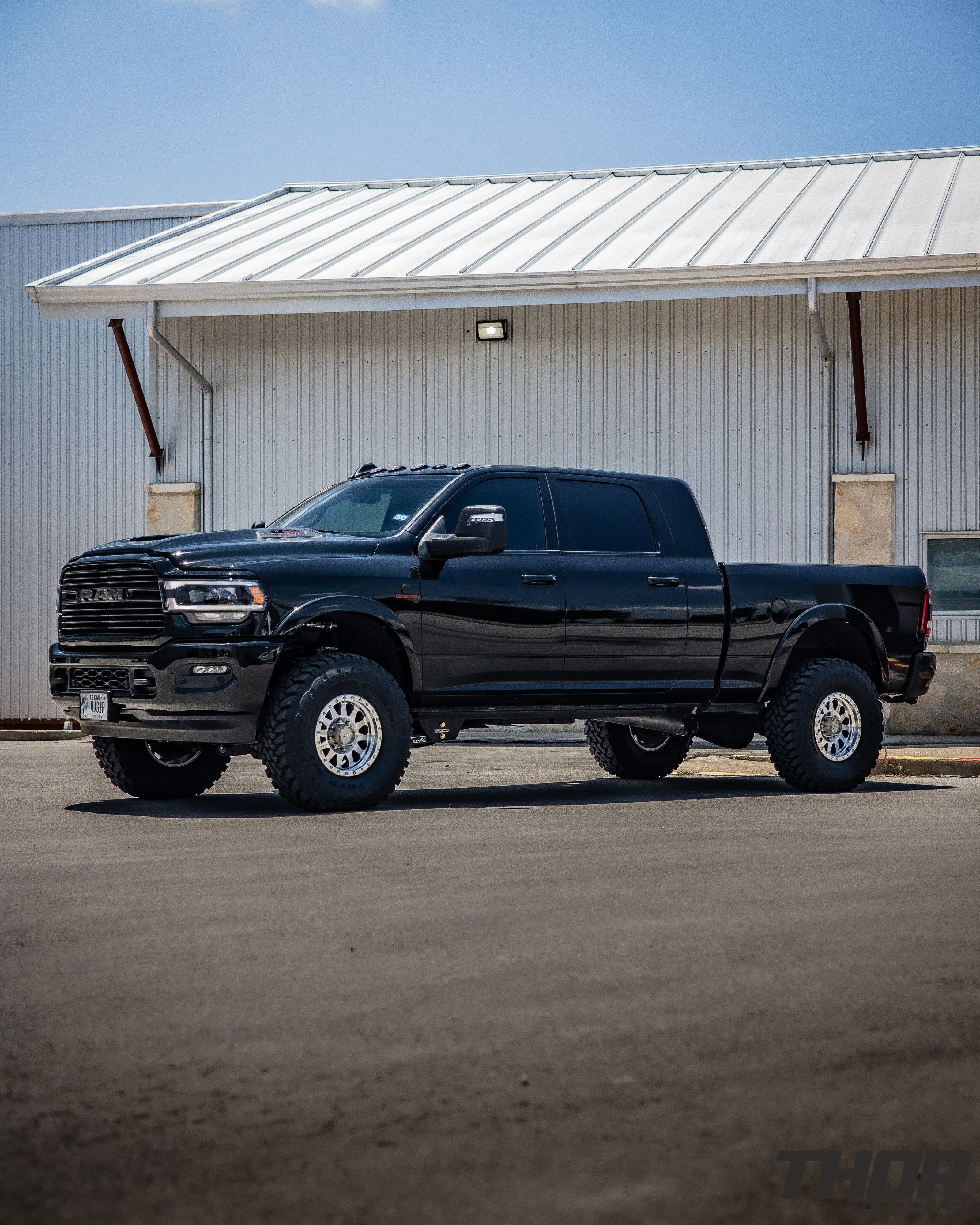 2024 RAM 3500 in Black with 3.25" Carli King Pintop Suspension, Carli Radius Drop Arm, Carli Low Mount Steering Stabilizer, Carli High Mount Steering Stabilizer, Carli Progressive Leaf Spring Kit, Carli Torsion Sway Bar, OEM Fender Flares, BW Tow and Stow