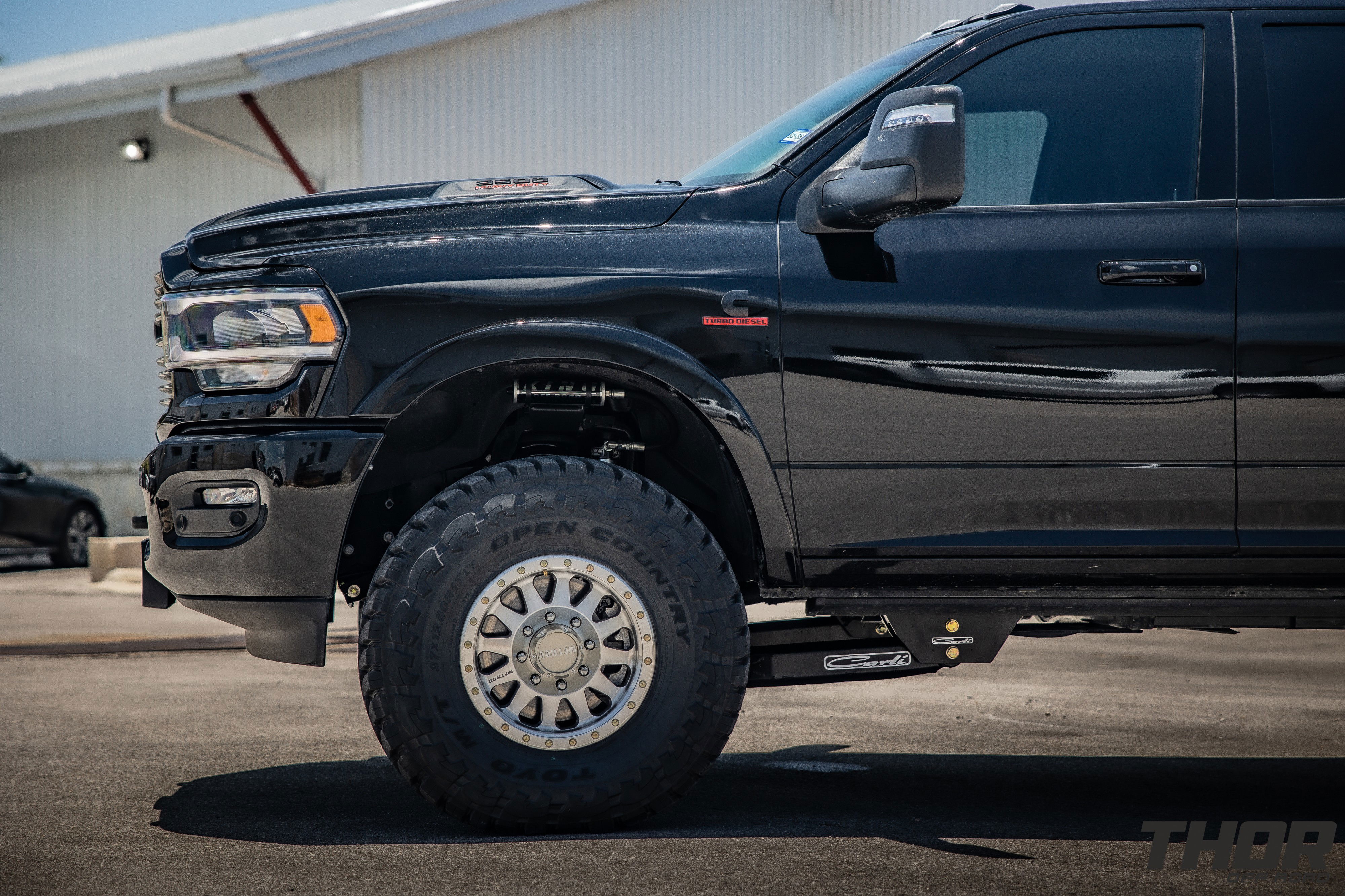 2024 RAM 3500 in Black with 3.25" Carli King Pintop Suspension, Carli Radius Drop Arm, Carli Low Mount Steering Stabilizer, Carli High Mount Steering Stabilizer, Carli Progressive Leaf Spring Kit, Carli Torsion Sway Bar, OEM Fender Flares, BW Tow and Stow