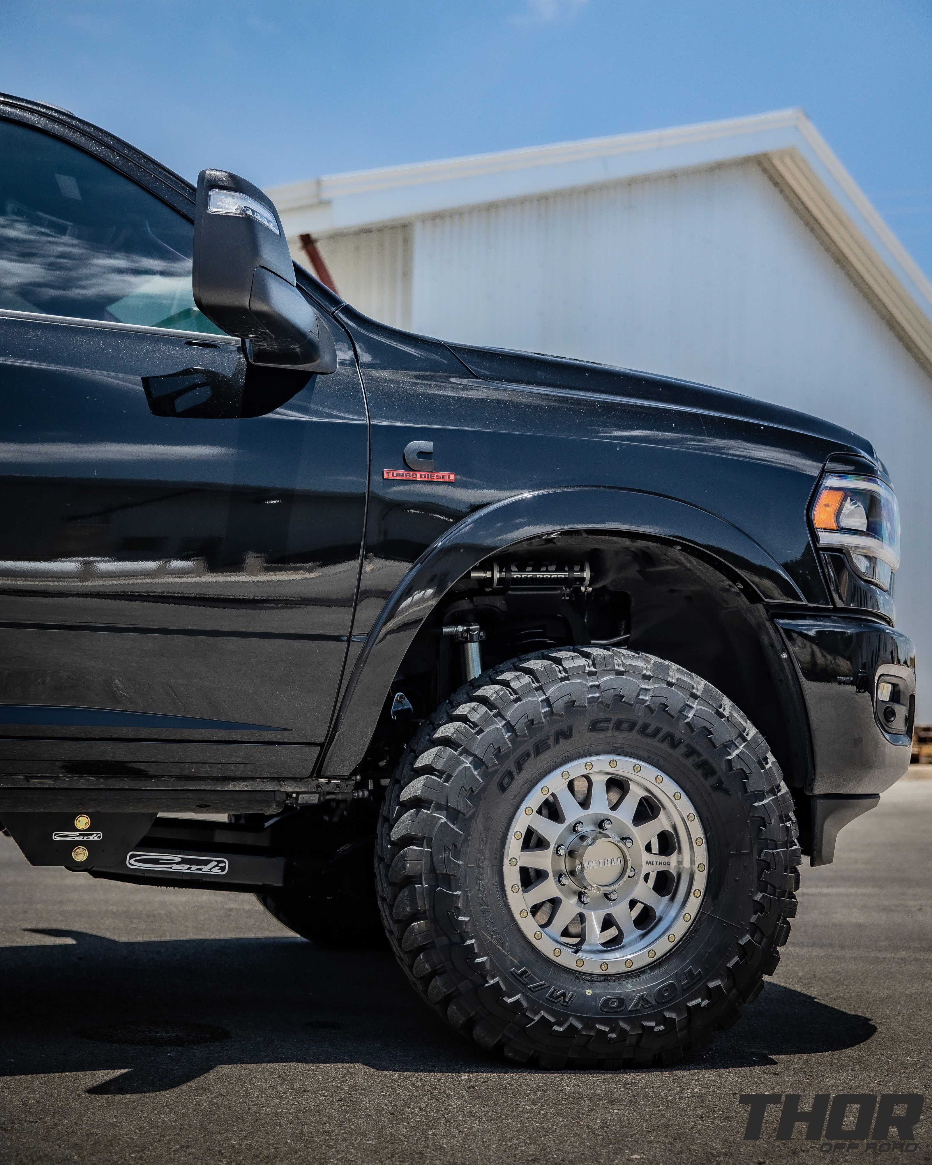 2024 RAM 3500 in Black with 3.25" Carli King Pintop Suspension, Carli Radius Drop Arm, Carli Low Mount Steering Stabilizer, Carli High Mount Steering Stabilizer, Carli Progressive Leaf Spring Kit, Carli Torsion Sway Bar, OEM Fender Flares, BW Tow and Stow