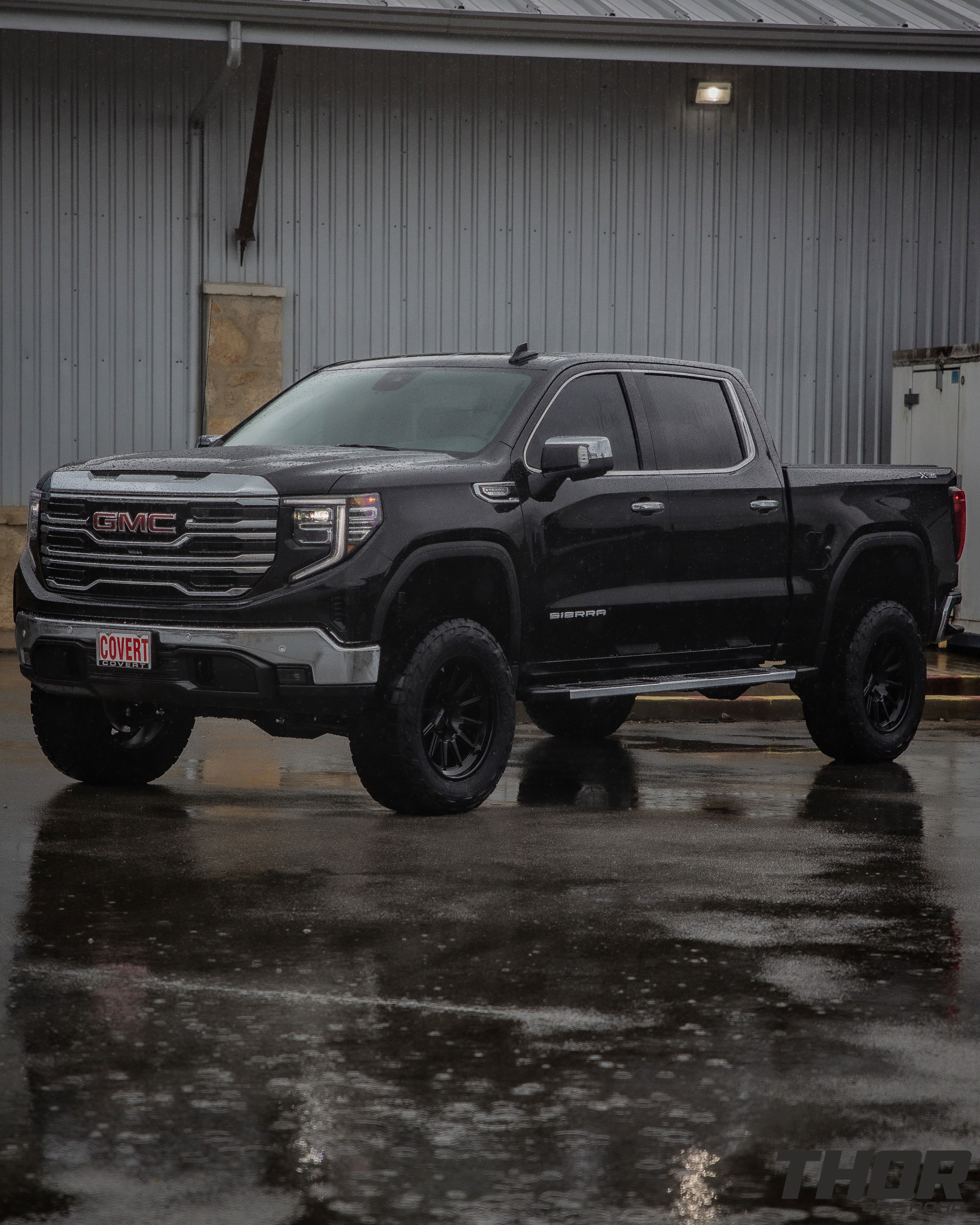 2024 GMC Sierra 1500 SLT in Black with 6" Lift Kit, Nitto Recon Grappler A/T 35x12.50R20 Tires, Method MR323 Gloss Black 20x10" Wheels, BakFlip Tonneau Cover