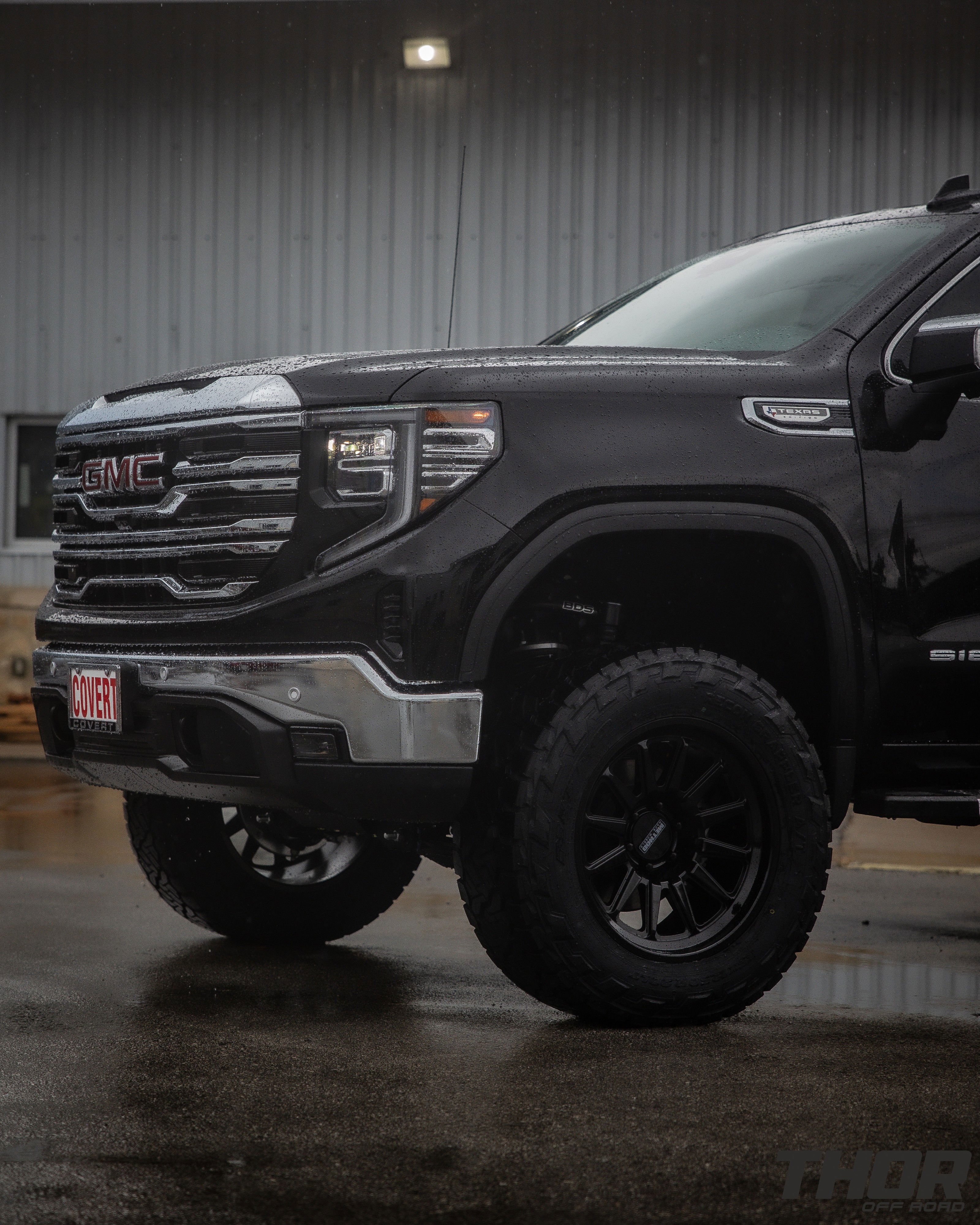 2024 GMC Sierra 1500 SLT in Black with 6" Lift Kit, Nitto Recon Grappler A/T 35x12.50R20 Tires, Method MR323 Gloss Black 20x10" Wheels, BakFlip Tonneau Cover