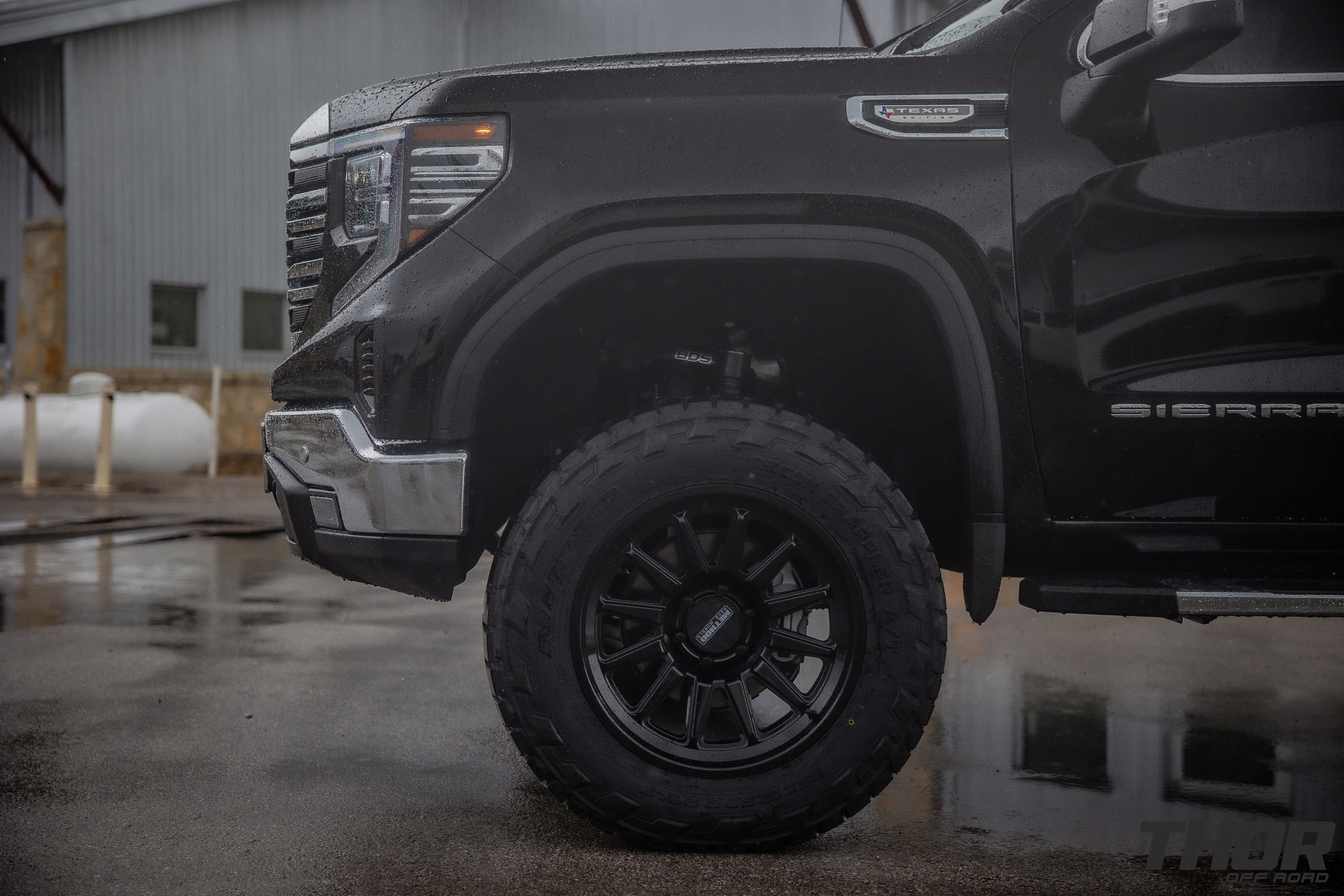 2024 GMC Sierra 1500 SLT in Black with 6" Lift Kit, Nitto Recon Grappler A/T 35x12.50R20 Tires, Method MR323 Gloss Black 20x10" Wheels, BakFlip Tonneau Cover