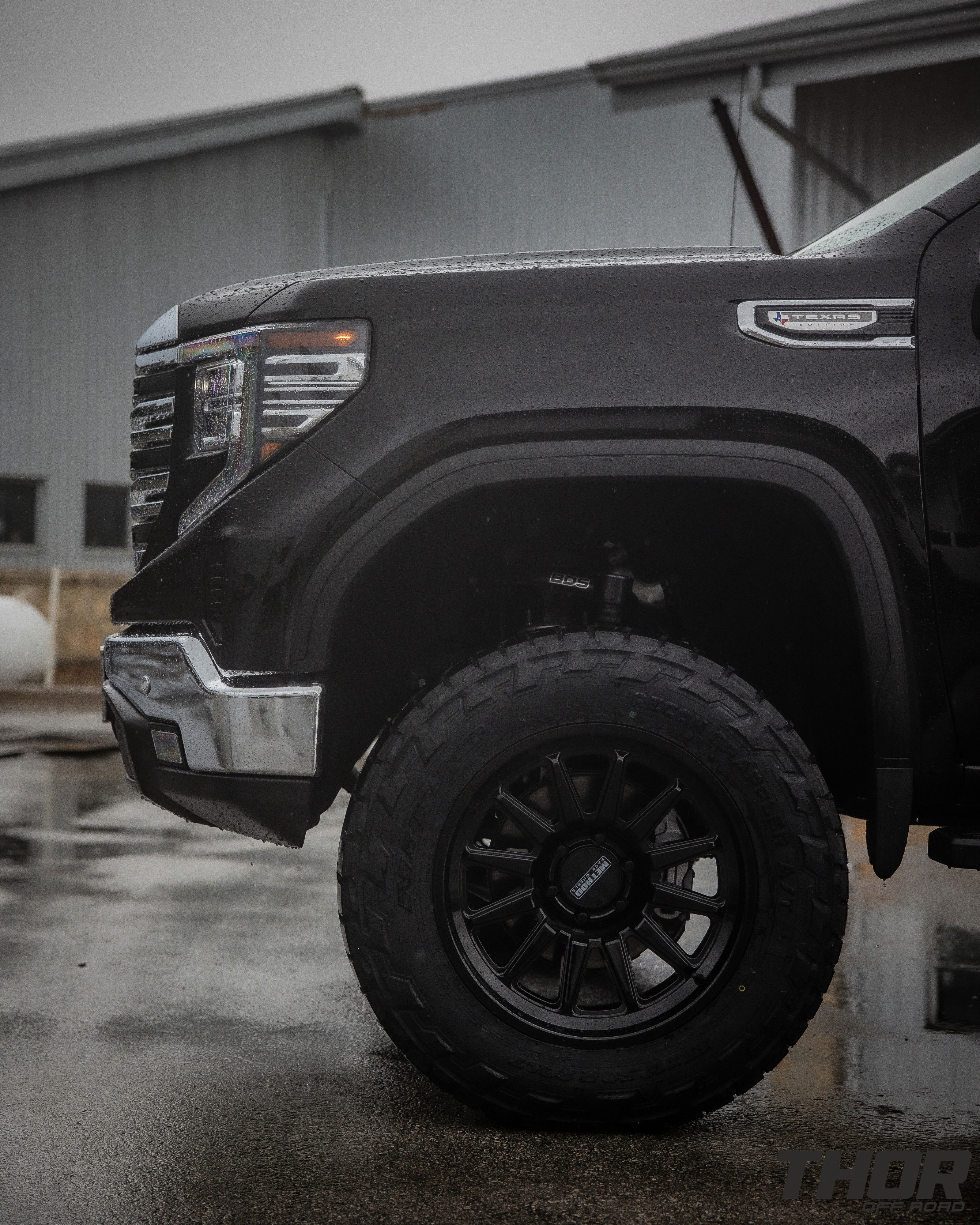 2024 GMC Sierra 1500 SLT in Black with 6" Lift Kit, Nitto Recon Grappler A/T 35x12.50R20 Tires, Method MR323 Gloss Black 20x10" Wheels, BakFlip Tonneau Cover