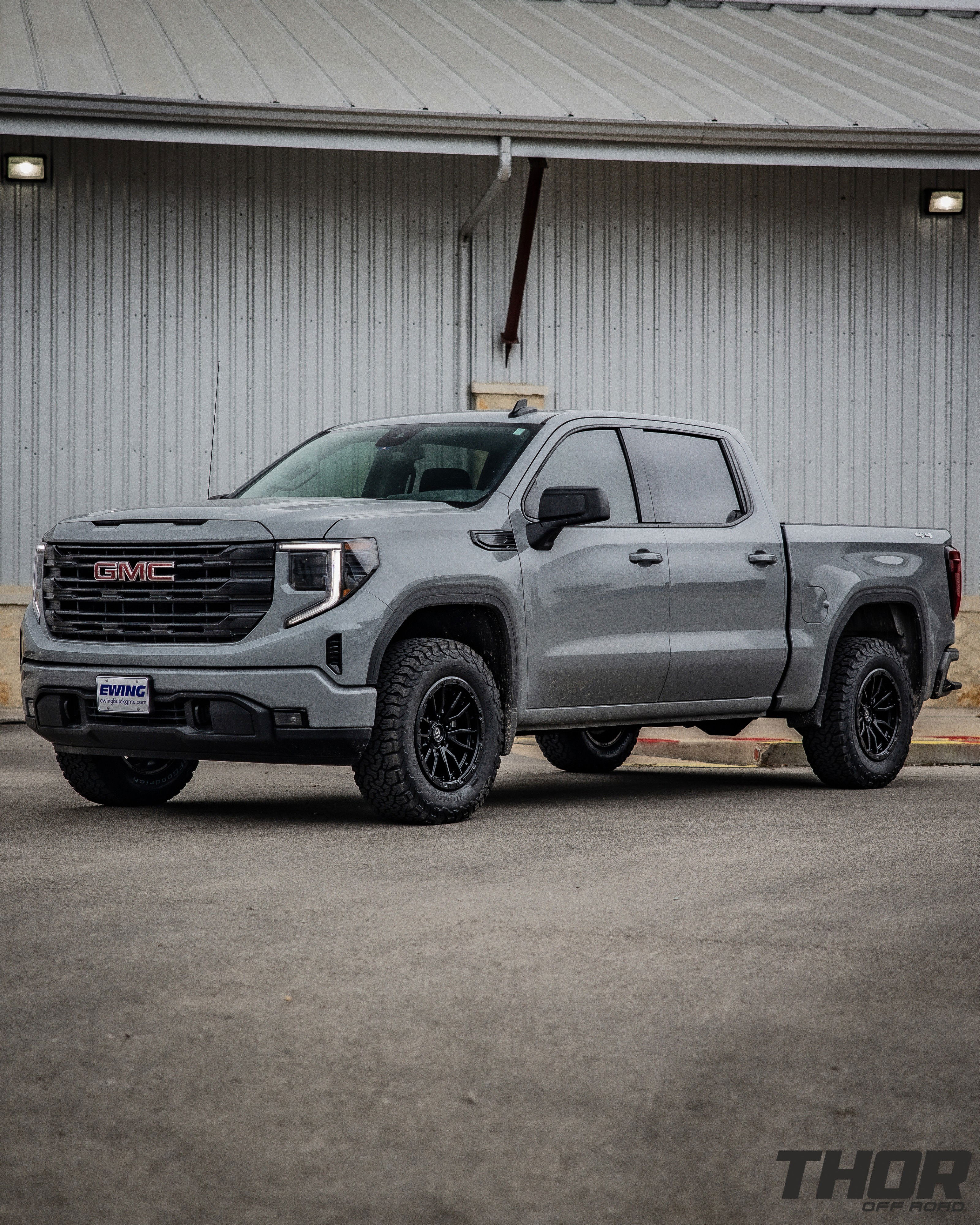 2024 GMC Sierra 1500 in Grey with Rough Country 2" Leveling Kit, BF Goodrich A/T KO2 35x12.50R20 Tires, Fuel Rebel Matte Black 18x9" Wheels, Spray in Bedliner, BakFlip Tonneau Cover