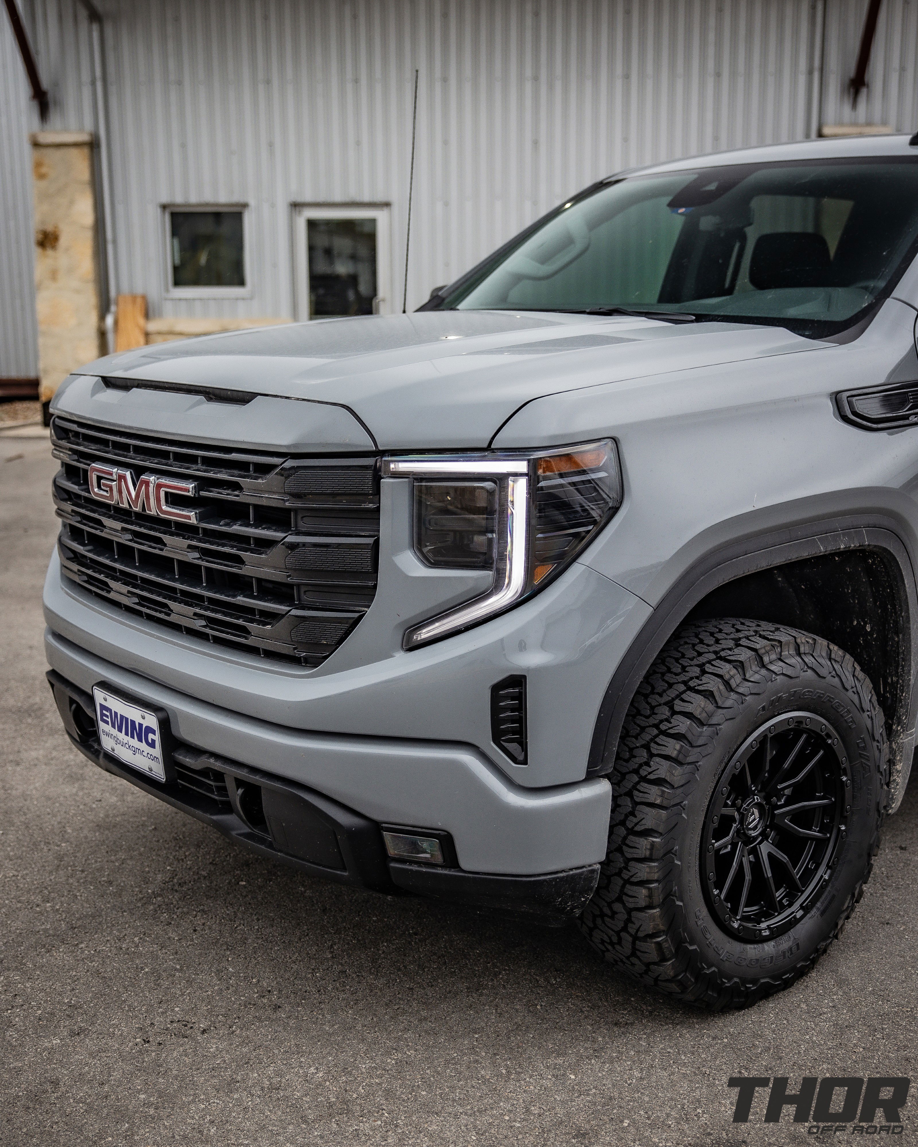 2024 GMC Sierra 1500 in Grey with Rough Country 2" Leveling Kit, BF Goodrich A/T KO2 35x12.50R20 Tires, Fuel Rebel Matte Black 18x9" Wheels, Spray in Bedliner, BakFlip Tonneau Cover