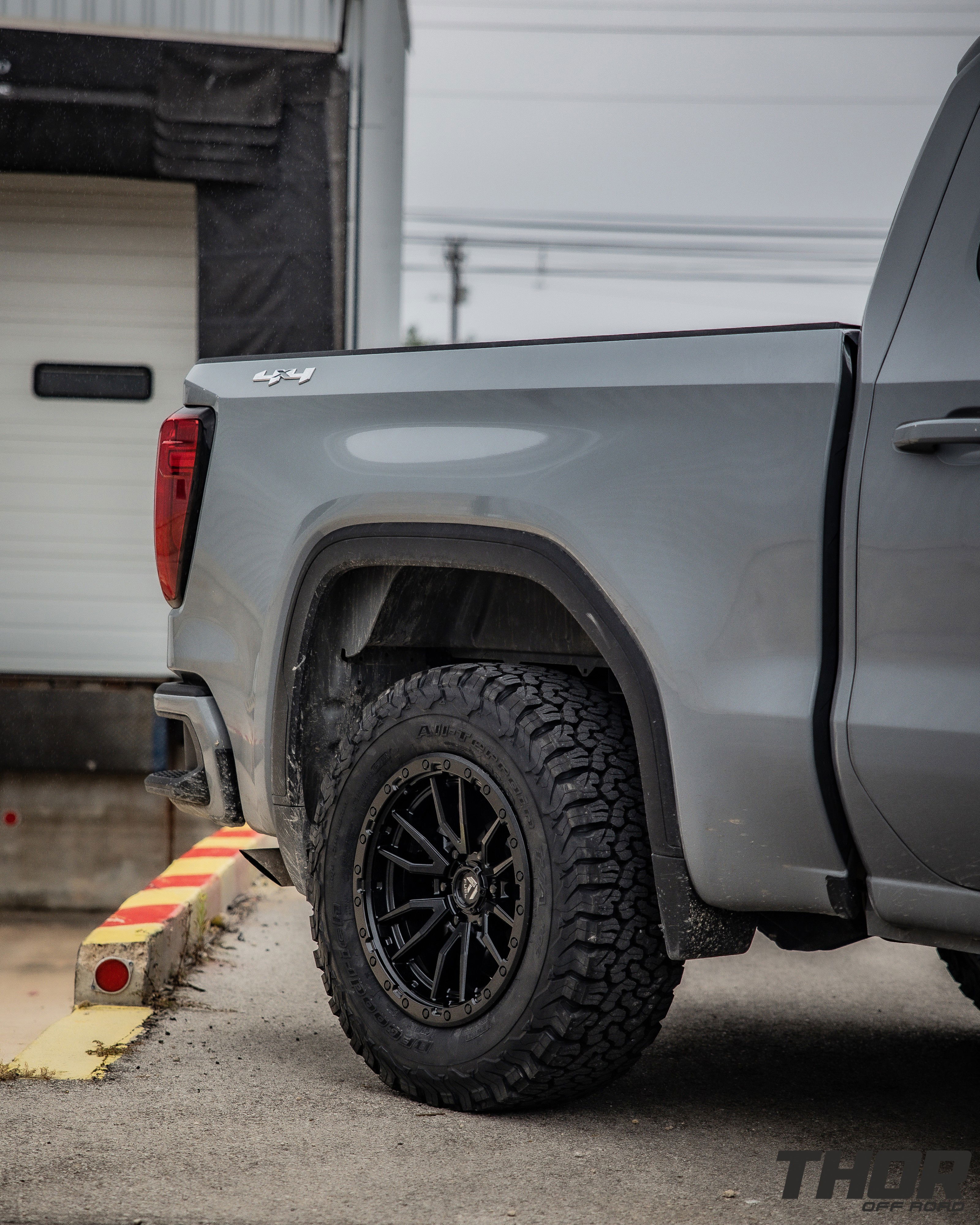 2024 GMC Sierra 1500 in Grey with Rough Country 2" Leveling Kit, BF Goodrich A/T KO2 35x12.50R20 Tires, Fuel Rebel Matte Black 18x9" Wheels, Spray in Bedliner, BakFlip Tonneau Cover