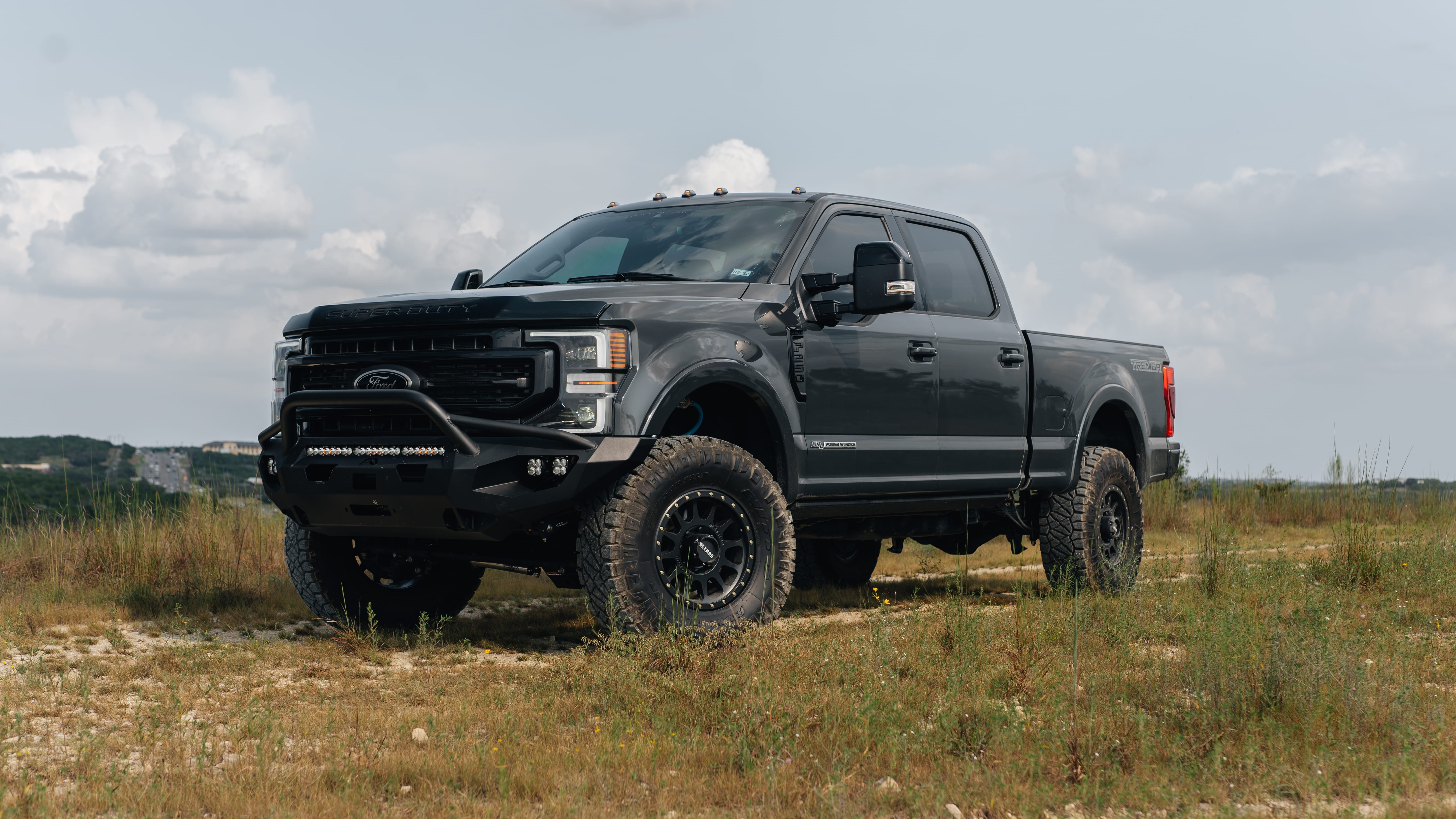2021 Ford F-250 Super Duty Lariat in Lithium Grey with Carli 3.5" Pintop Suspension Kit, 18" Method 305HD Wheels, 37x12.50R18 Nitto Ridge Grappler Tires, BedSlide Retractable Bed, Fab Fours Front Bumper, Baja Squadron Fog Lights, Baja Design 30" Light Bar