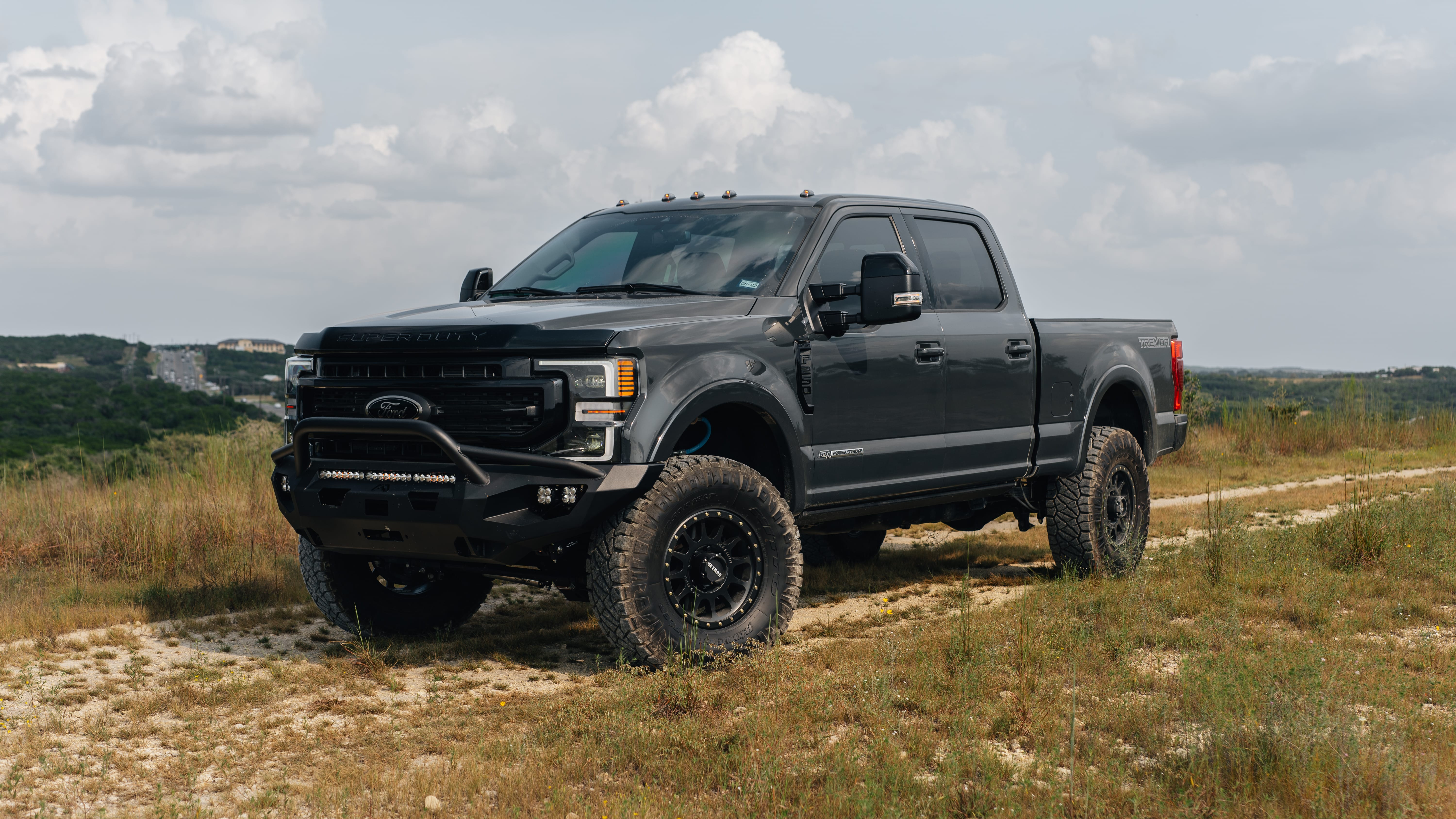 2021 Ford F-250 Super Duty Lariat in Lithium Grey with Carli 3.5" Pintop Suspension Kit, 18" Method 305HD Wheels, 37x12.50R18 Nitto Ridge Grappler Tires, BedSlide Retractable Bed, Fab Fours Front Bumper, Baja Squadron Fog Lights, Baja Design 30" Light Bar