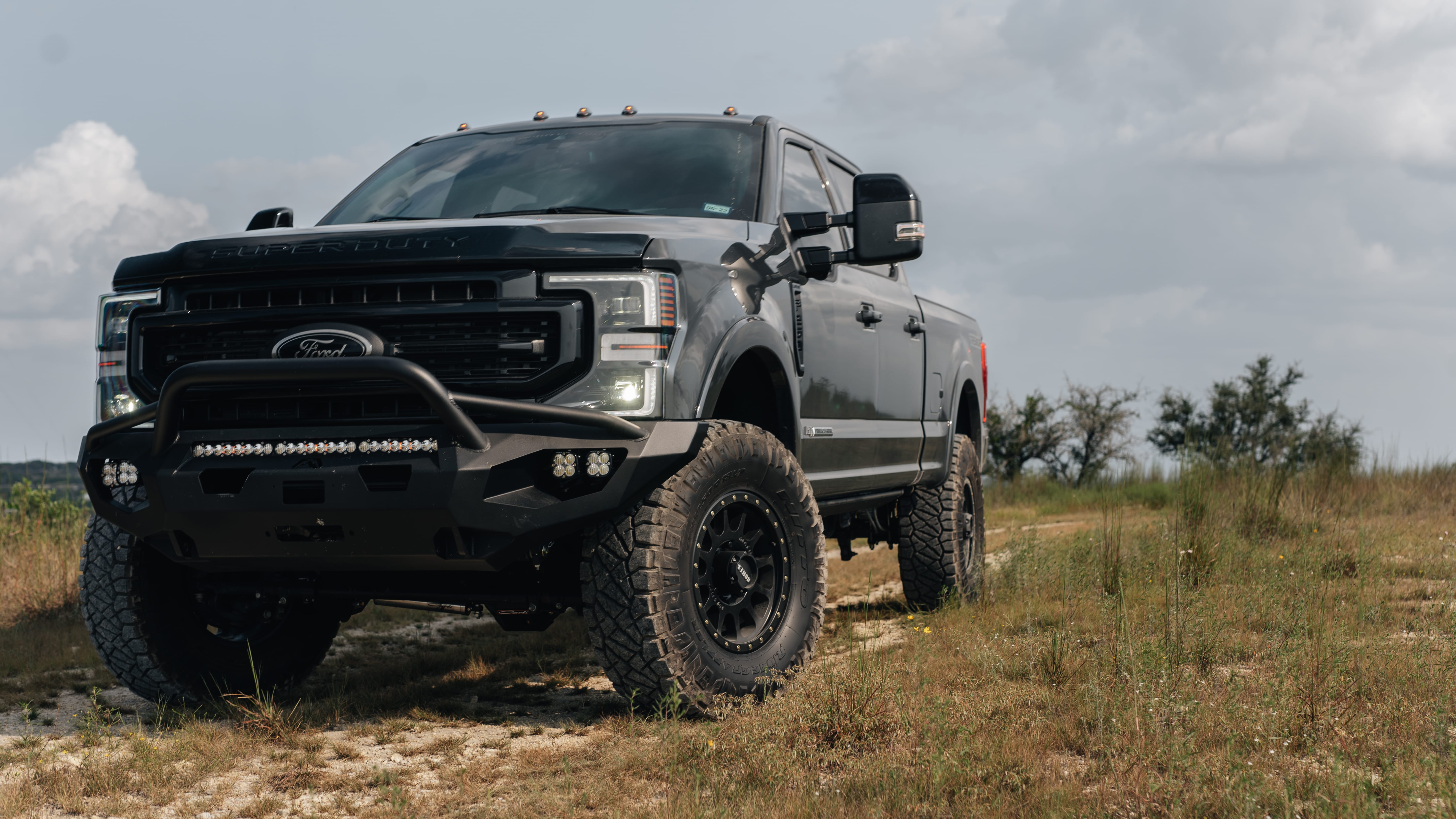 2021 Ford F-250 Super Duty Lariat in Lithium Grey with Carli 3.5" Pintop Suspension Kit, 18" Method 305HD Wheels, 37x12.50R18 Nitto Ridge Grappler Tires, BedSlide Retractable Bed, Fab Fours Front Bumper, Baja Squadron Fog Lights, Baja Design 30" Light Bar