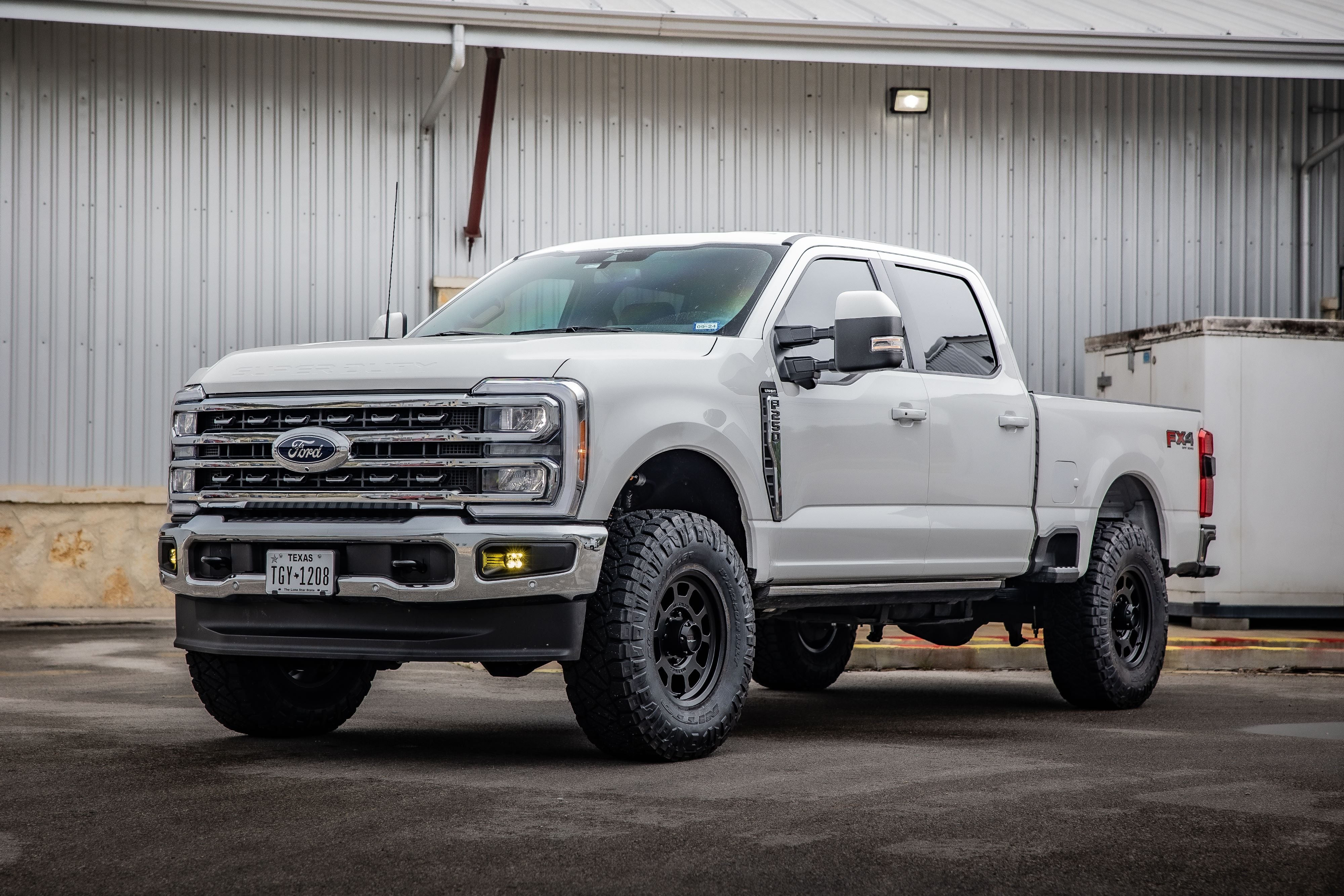 2023 Ford F-250 Super Duty Lariat in White with Carli 3.5" Backcountry Suspension Kit, Carli 3.5" Full Rear Spring Replacement, Carli High Mount Steering Stabilizer, Carli Low Mount Steering Stabilizer, Carli Torsion Sway Bar, Carli Fabricated Radius Arms, Method MR705 18x9" Wheels, 37x12.50R18 Nitto Ridge Grappler Tires, Spray in Bedliner
