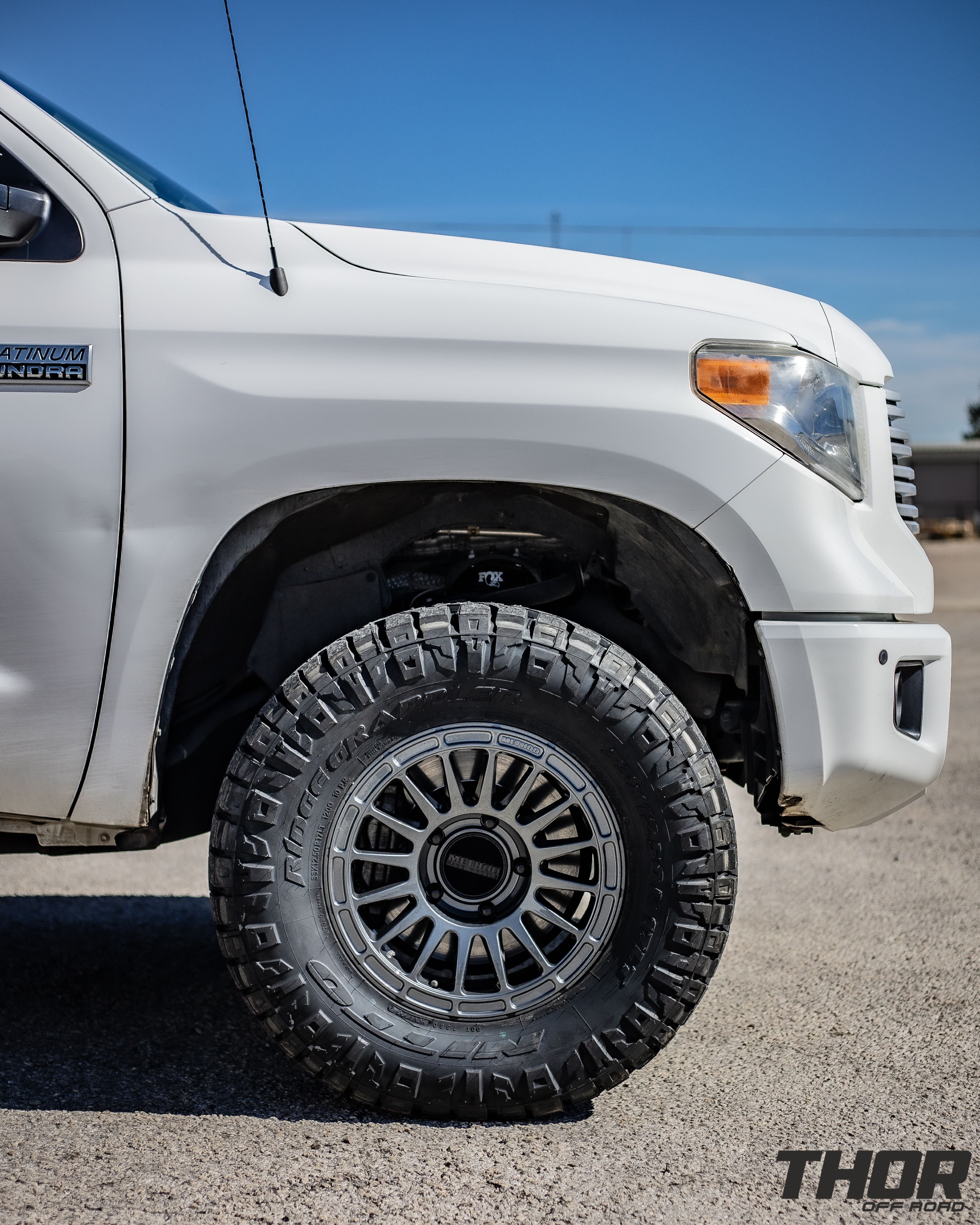 2016 Toyota Tundra Platinum in White with Fox 2.0 Leveling Kit, Method Racing MR 314 Titanium Gloss 17" Wheels, 33x12.50R17 Nitto Ridge Grappler Tires