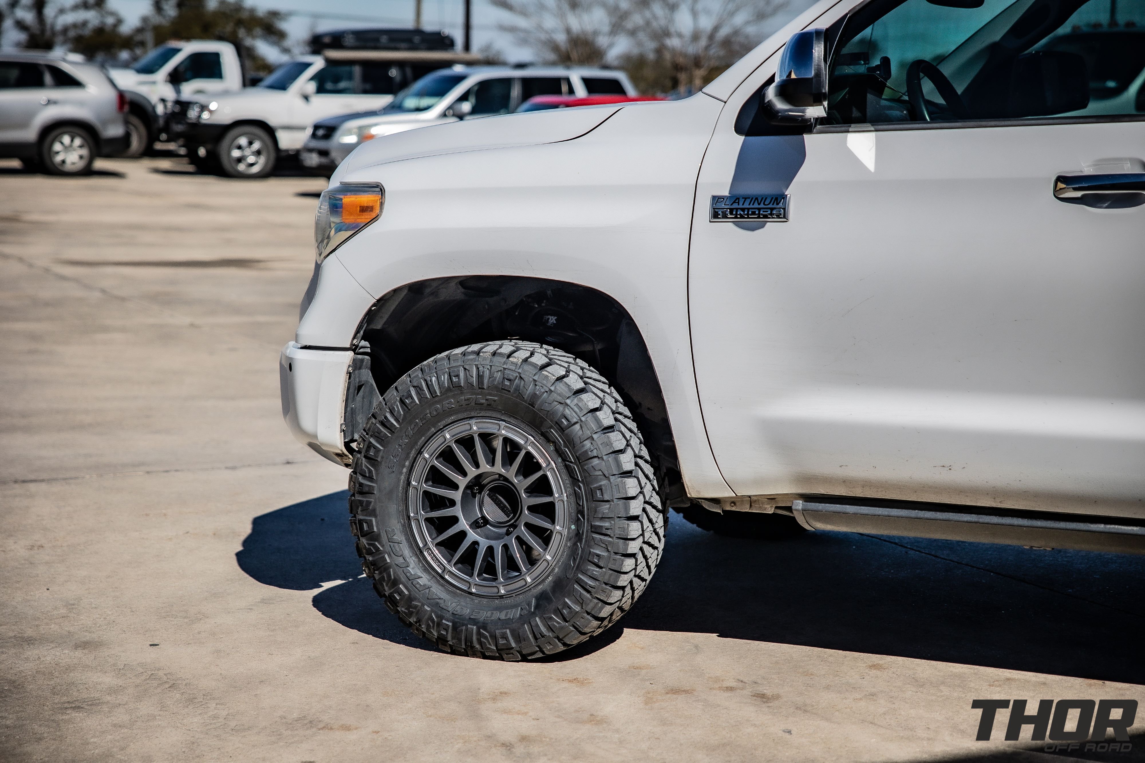 2016 Toyota Tundra Platinum in White with Fox 2.0 Leveling Kit, Method Racing MR 314 Titanium Gloss 17" Wheels, 33x12.50R17 Nitto Ridge Grappler Tires