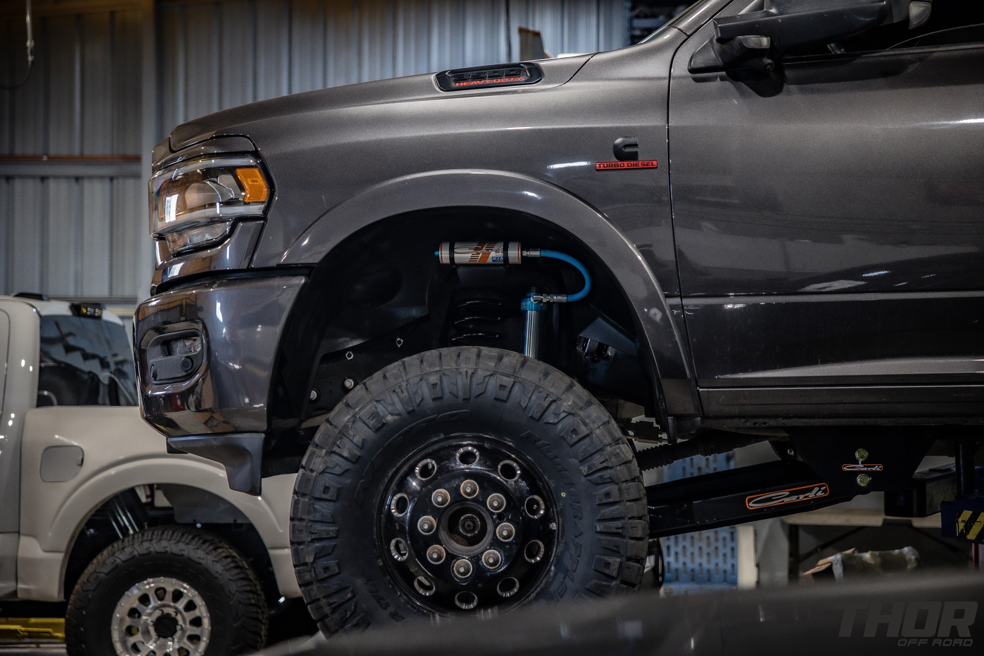 2022 RAM 3500 in Grey with Carli 3" Pintop Suspension System, Carli Fabricated Radius Arms, Carli Low Mount Steering Stabilizer, Carli High Mount Steering Stabilizer, Carli Ball Joints, Carli Add-a-Pack, Air Lift 5000 Load Lifter Kit, 37x12.50R17 Nitto Ridge Grappler Tires