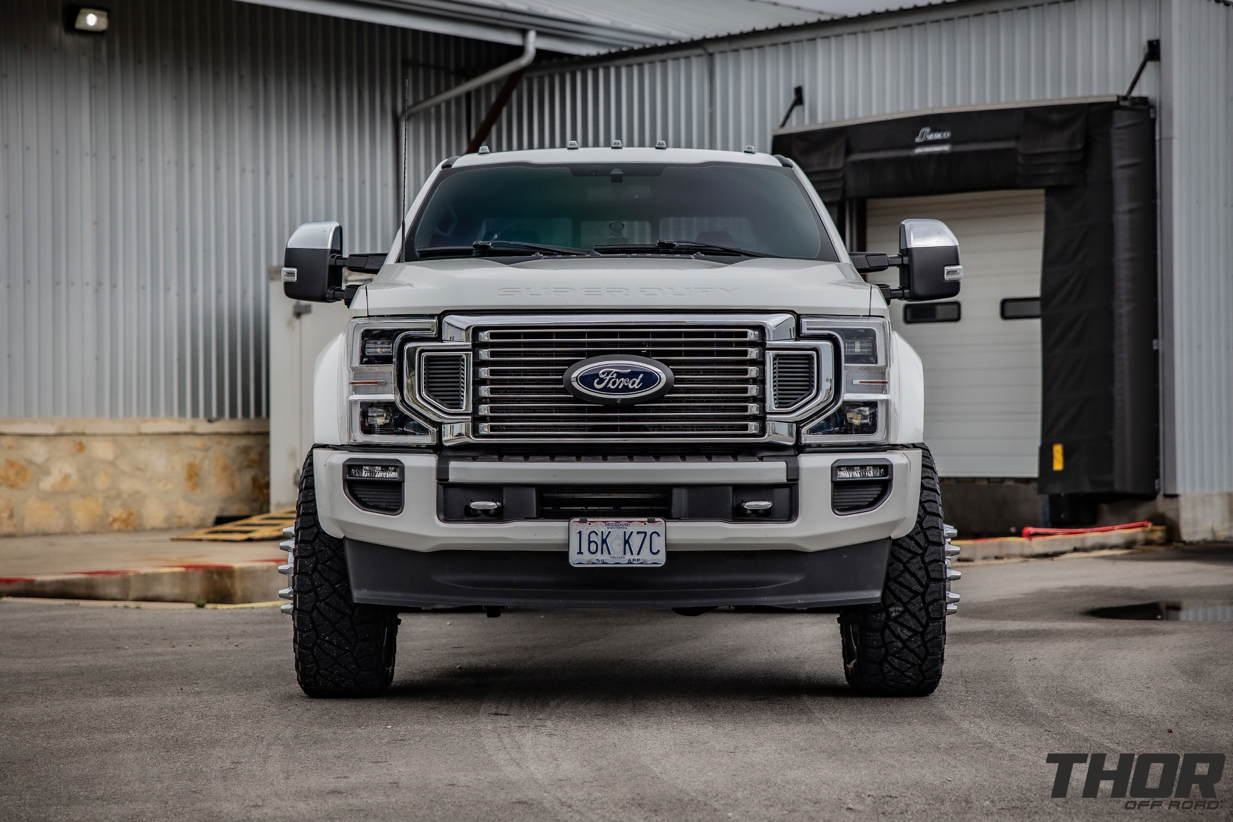 2022 Ford F-450 Super Duty Platinum in White with Carli 3.5" E-Venture Suspension Kit, Carli Sway Bar, Carli Fabricated Radius Arms, Carli Full Rear Spring Replacement, LoadLifter 5000 Air Spring Kit, 22" KG1 Forged KD006 Wheels, 37x12.50R22 Nitto Ridge Grappler Tires