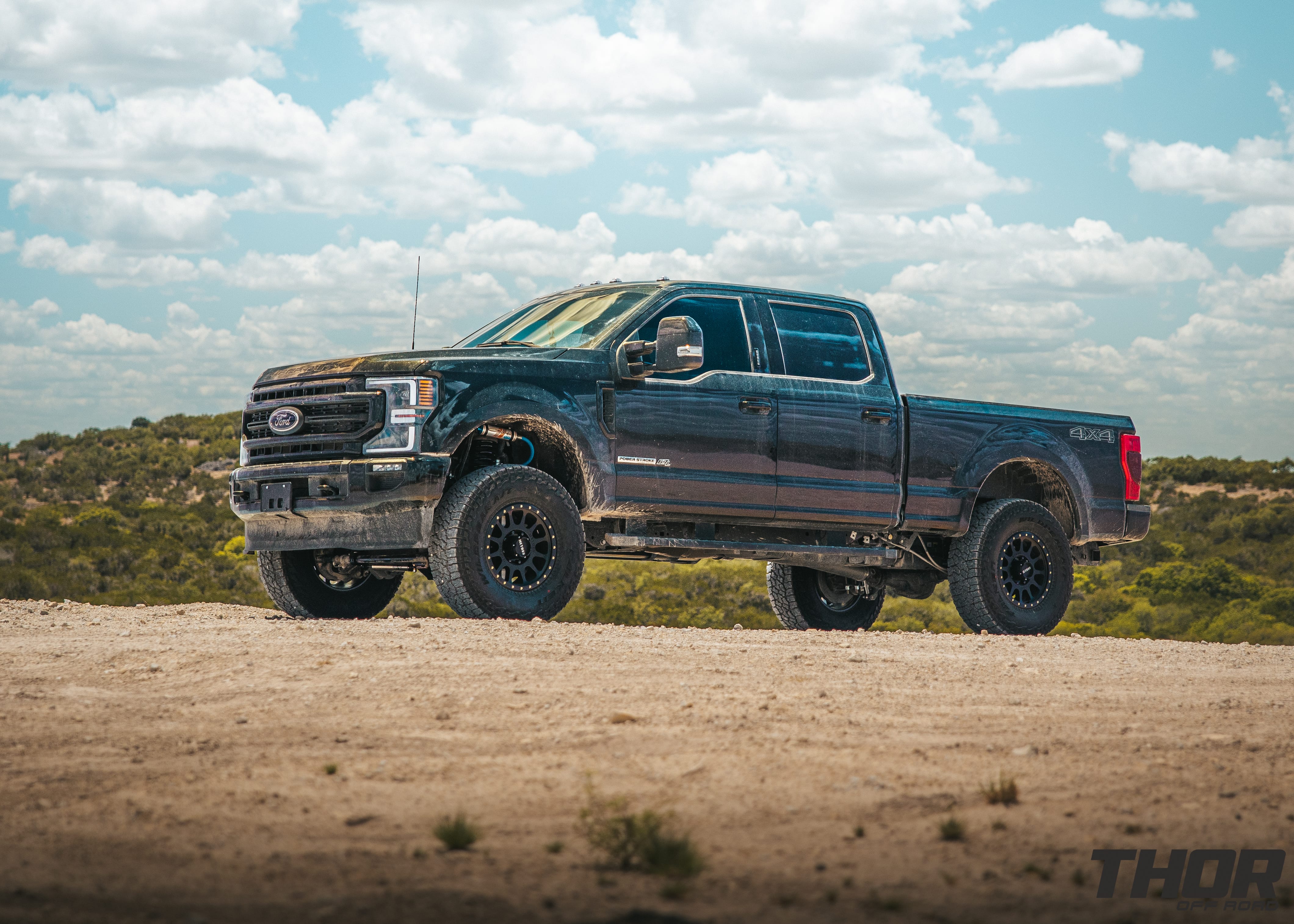 2022 Ford F-250 Super Duty Lariat in Black with Carli 3.5" Pintop Suspension Kit, Carli Torsion Sway Bar, Carli High Mount Steering Stabilizer, Carli Low Mount Steering Stabilizer, Carli Radius Arms, Air Bag Lift Kit with Wireless Controller, 18x9" Method MR305 NV Matte Black Wheels, 37x12.50R18 Falken Wildpeak A/T3W Tires