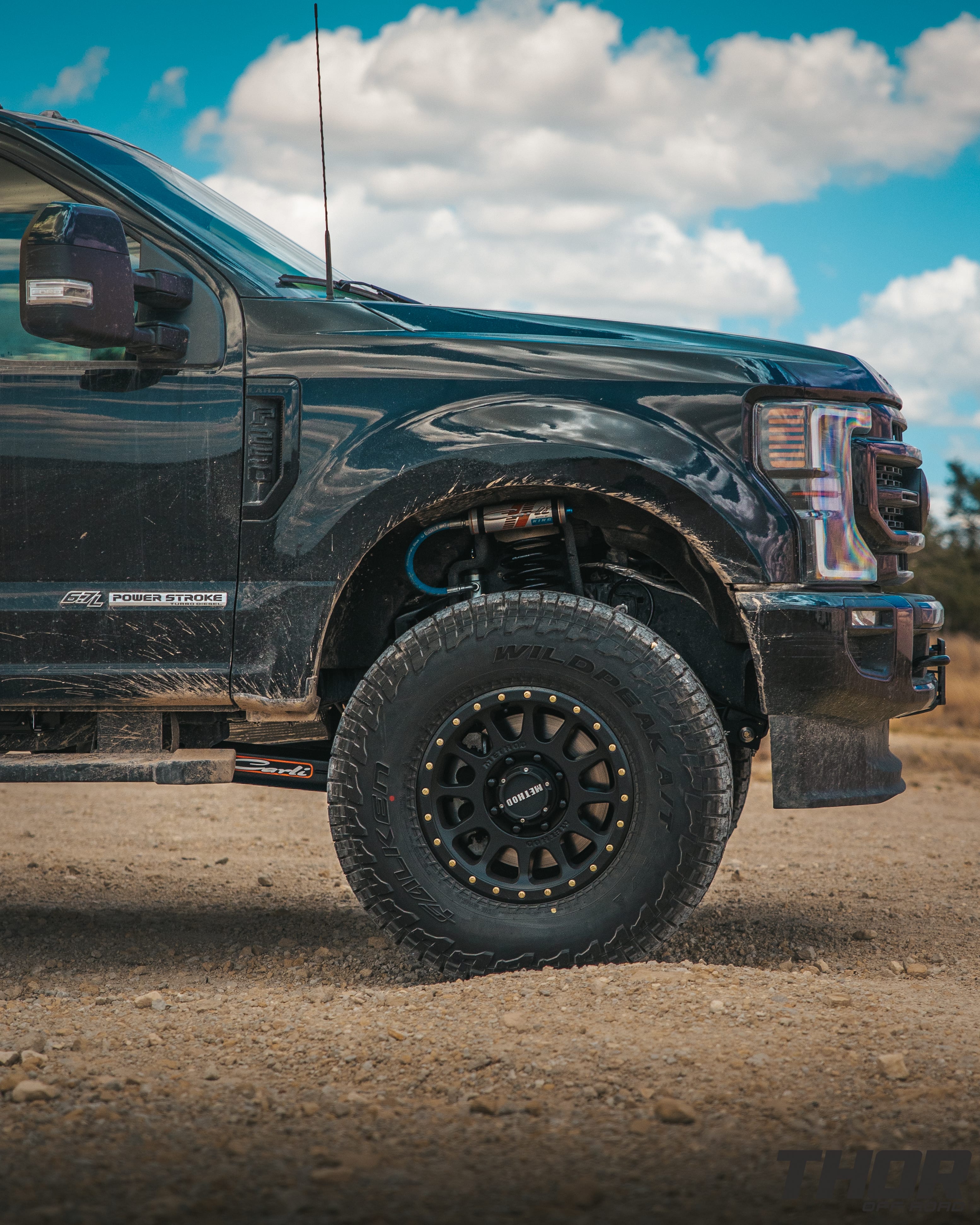 2022 Ford F-250 Super Duty Lariat in Black with Carli 3.5" Pintop Suspension Kit, Carli Torsion Sway Bar, Carli High Mount Steering Stabilizer, Carli Low Mount Steering Stabilizer, Carli Radius Arms, Air Bag Lift Kit with Wireless Controller, 18x9" Method MR305 NV Matte Black Wheels, 37x12.50R18 Falken Wildpeak A/T3W Tires