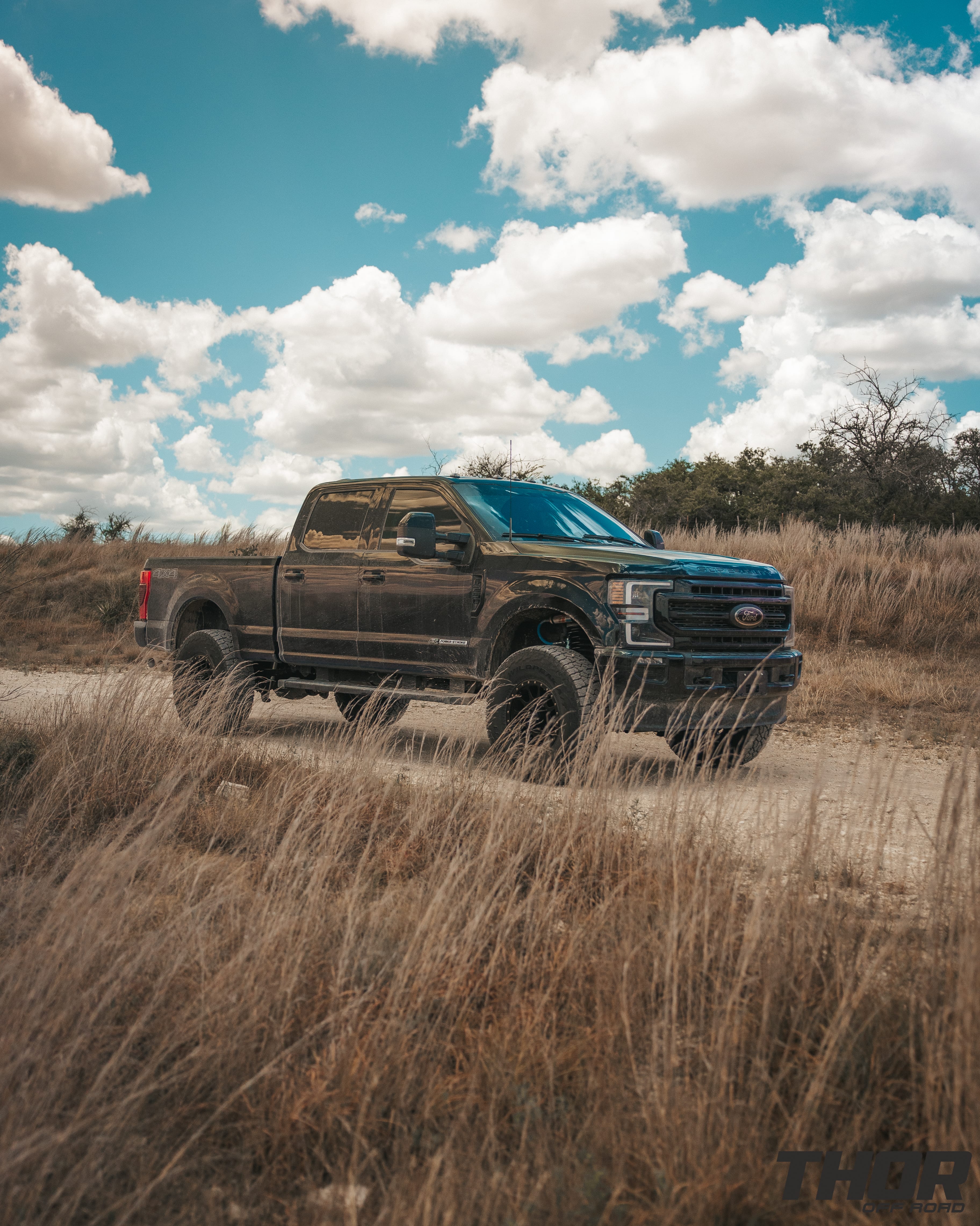 2022 Ford F-250 Super Duty Lariat in Black with Carli 3.5" Pintop Suspension Kit, Carli Torsion Sway Bar, Carli High Mount Steering Stabilizer, Carli Low Mount Steering Stabilizer, Carli Radius Arms, Air Bag Lift Kit with Wireless Controller, 18x9" Method MR305 NV Matte Black Wheels, 37x12.50R18 Falken Wildpeak A/T3W Tires