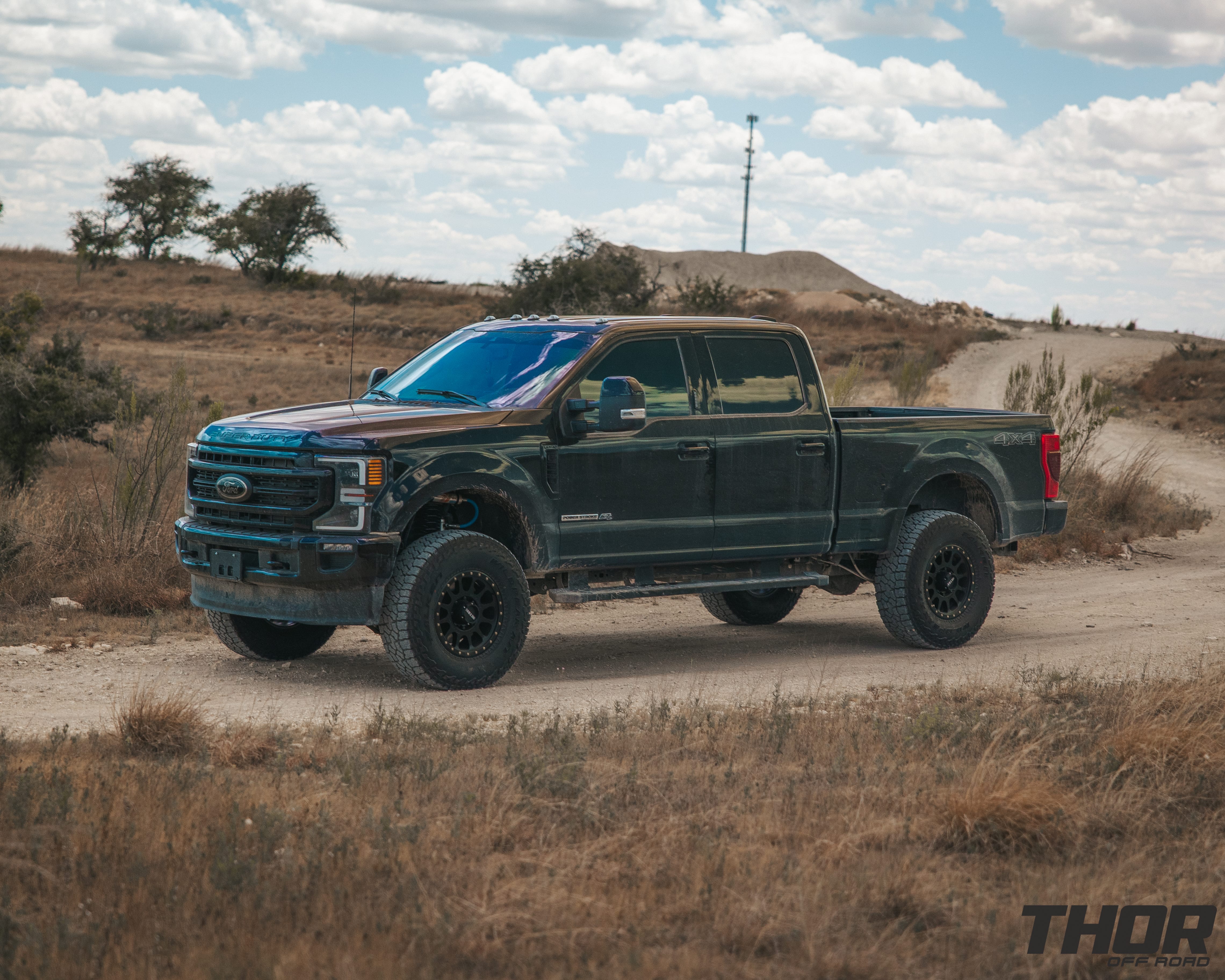 2022 Ford F-250 Super Duty Lariat in Black with Carli 3.5" Pintop Suspension Kit, Carli Torsion Sway Bar, Carli High Mount Steering Stabilizer, Carli Low Mount Steering Stabilizer, Carli Radius Arms, Air Bag Lift Kit with Wireless Controller, 18x9" Method MR305 NV Matte Black Wheels, 37x12.50R18 Falken Wildpeak A/T3W Tires