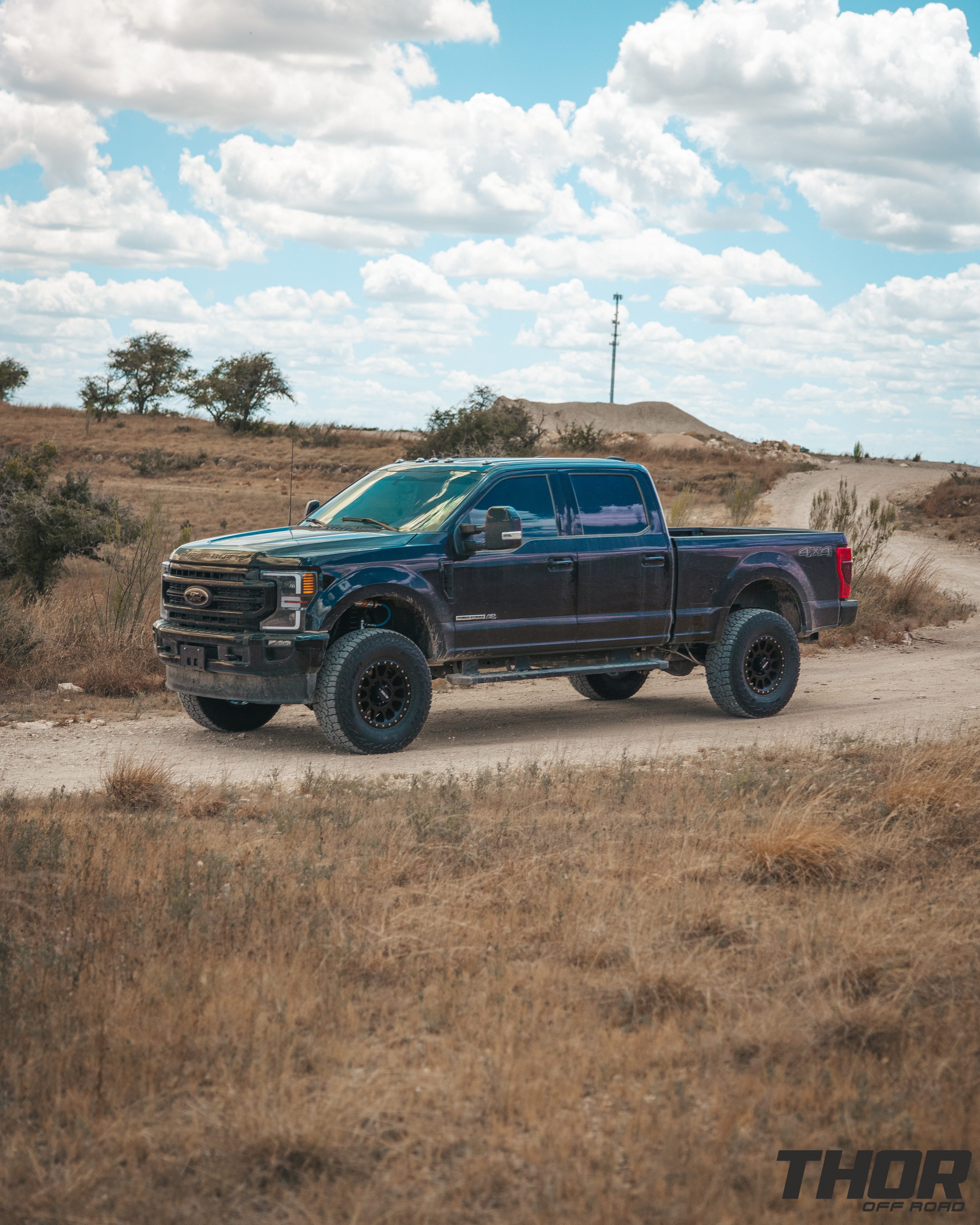 2022 Ford F-250 Super Duty Lariat in Black with Carli 3.5" Pintop Suspension Kit, Carli Torsion Sway Bar, Carli High Mount Steering Stabilizer, Carli Low Mount Steering Stabilizer, Carli Radius Arms, Air Bag Lift Kit with Wireless Controller, 18x9" Method MR305 NV Matte Black Wheels, 37x12.50R18 Falken Wildpeak A/T3W Tires