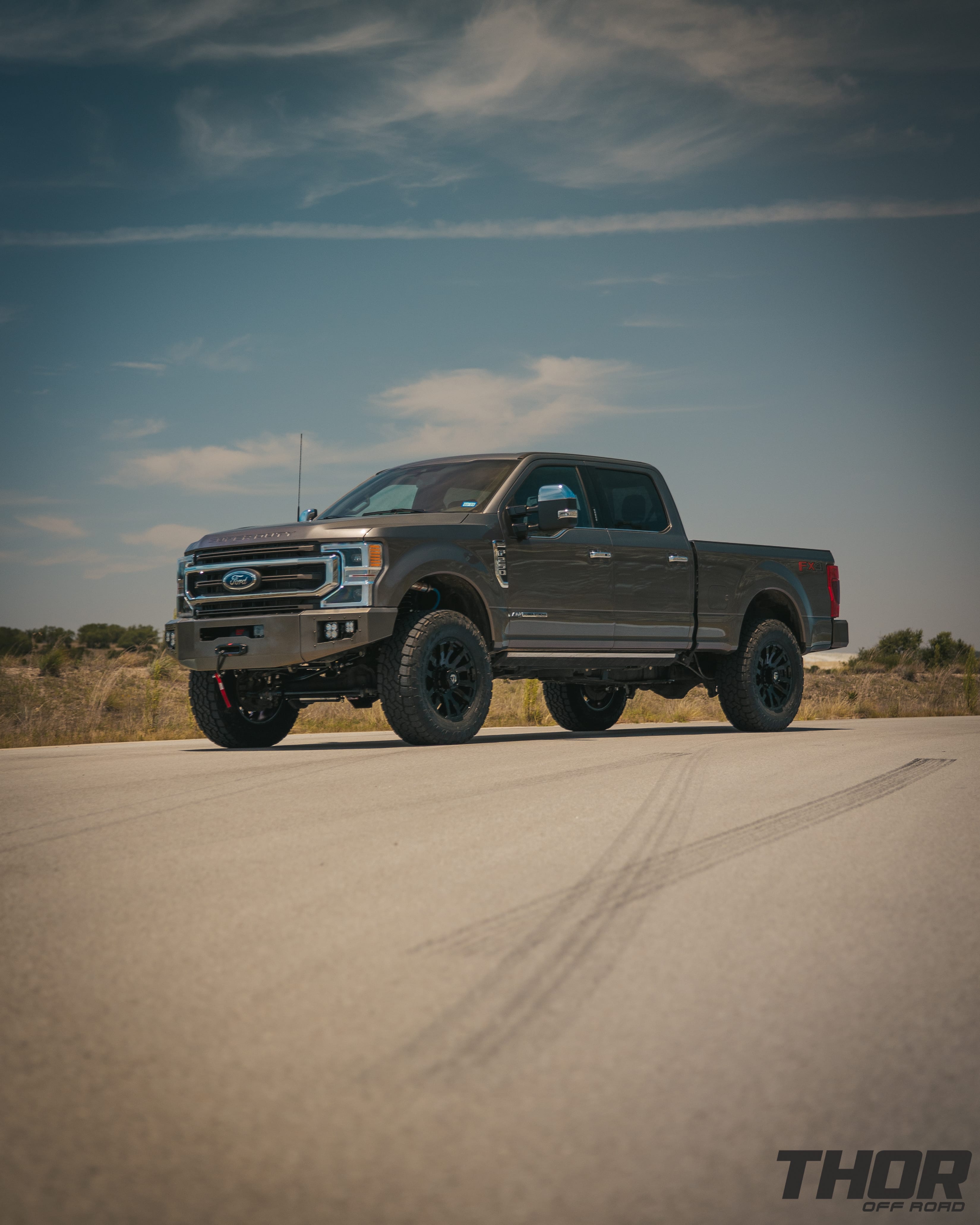 2022 Ford F-250 Super Duty King Ranch in Stone Grey with 3.5" Carli King Pintop Suspension Kit, Carli Torsion Sway Bar, Carli Fabricated Radius Arms, Carli Rear Full Leaf Springs, 20" Fuel Blitz Wheels, 37x12.50R20 Toyo ATIII Tires, CJC Front and Rear Bumpers, Baja Design XL Squadron Lighting, Warn 12S Winch