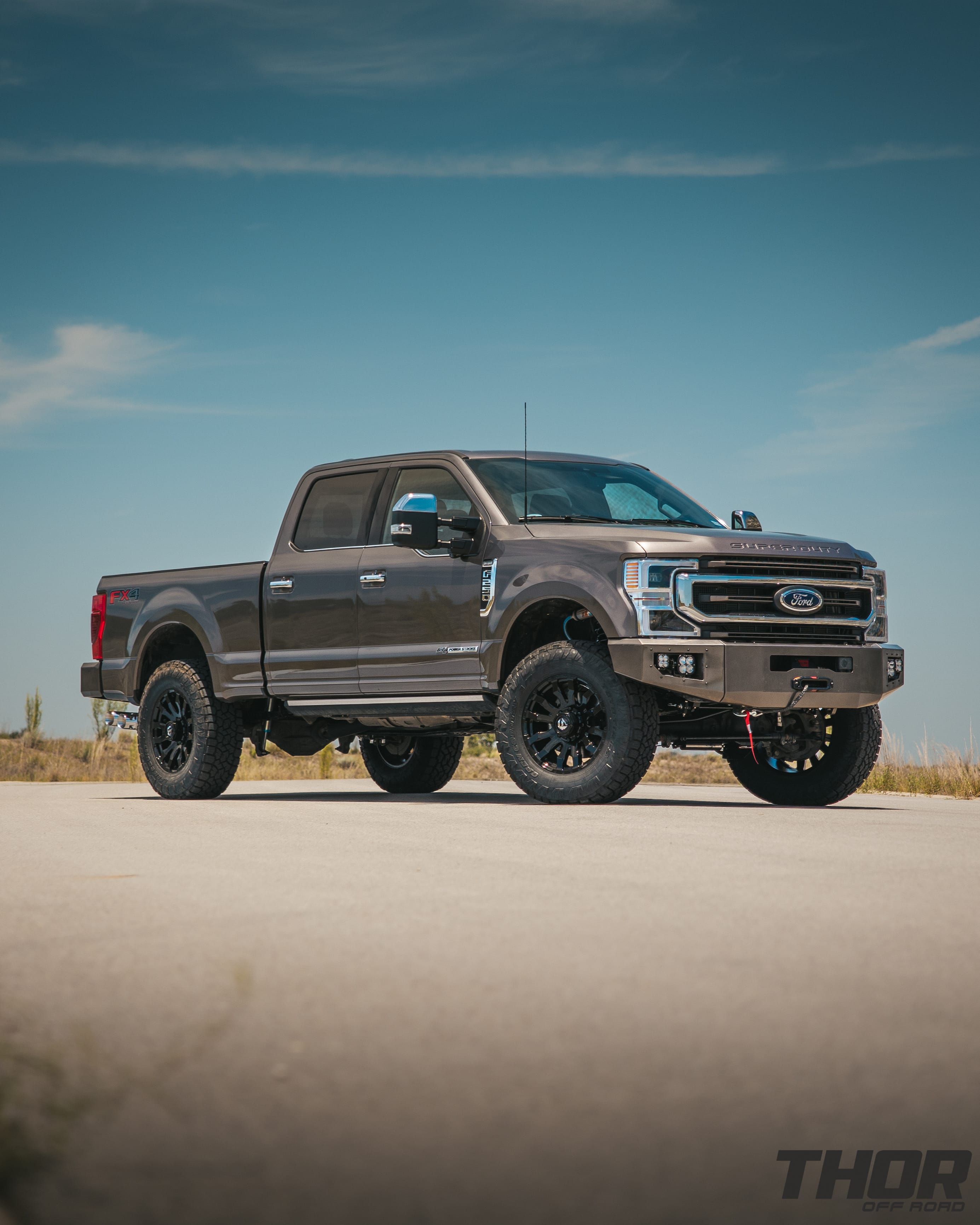 2022 Ford F-250 Super Duty King Ranch in Stone Grey with 3.5" Carli King Pintop Suspension Kit, Carli Torsion Sway Bar, Carli Fabricated Radius Arms, Carli Rear Full Leaf Springs, 20" Fuel Blitz Wheels, 37x12.50R20 Toyo ATIII Tires, CJC Front and Rear Bumpers, Baja Design XL Squadron Lighting, Warn 12S Winch