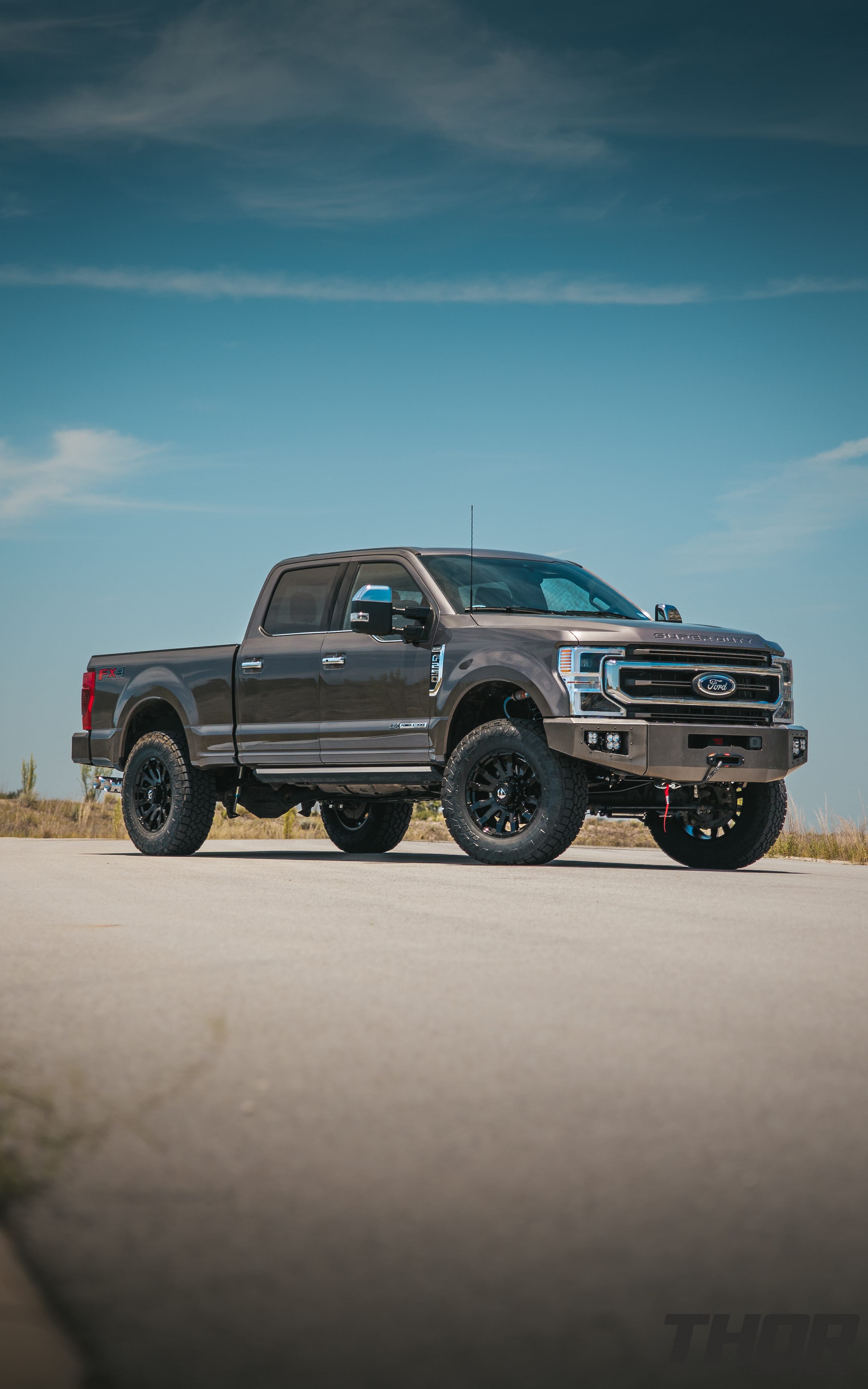 2022 Ford F-250 Super Duty King Ranch in Stone Grey with 3.5" Carli King Pintop Suspension Kit, Carli Torsion Sway Bar, Carli Fabricated Radius Arms, Carli Rear Full Leaf Springs, 20" Fuel Blitz Wheels, 37x12.50R20 Toyo ATIII Tires, CJC Front and Rear Bumpers, Baja Design XL Squadron Lighting, Warn 12S Winch