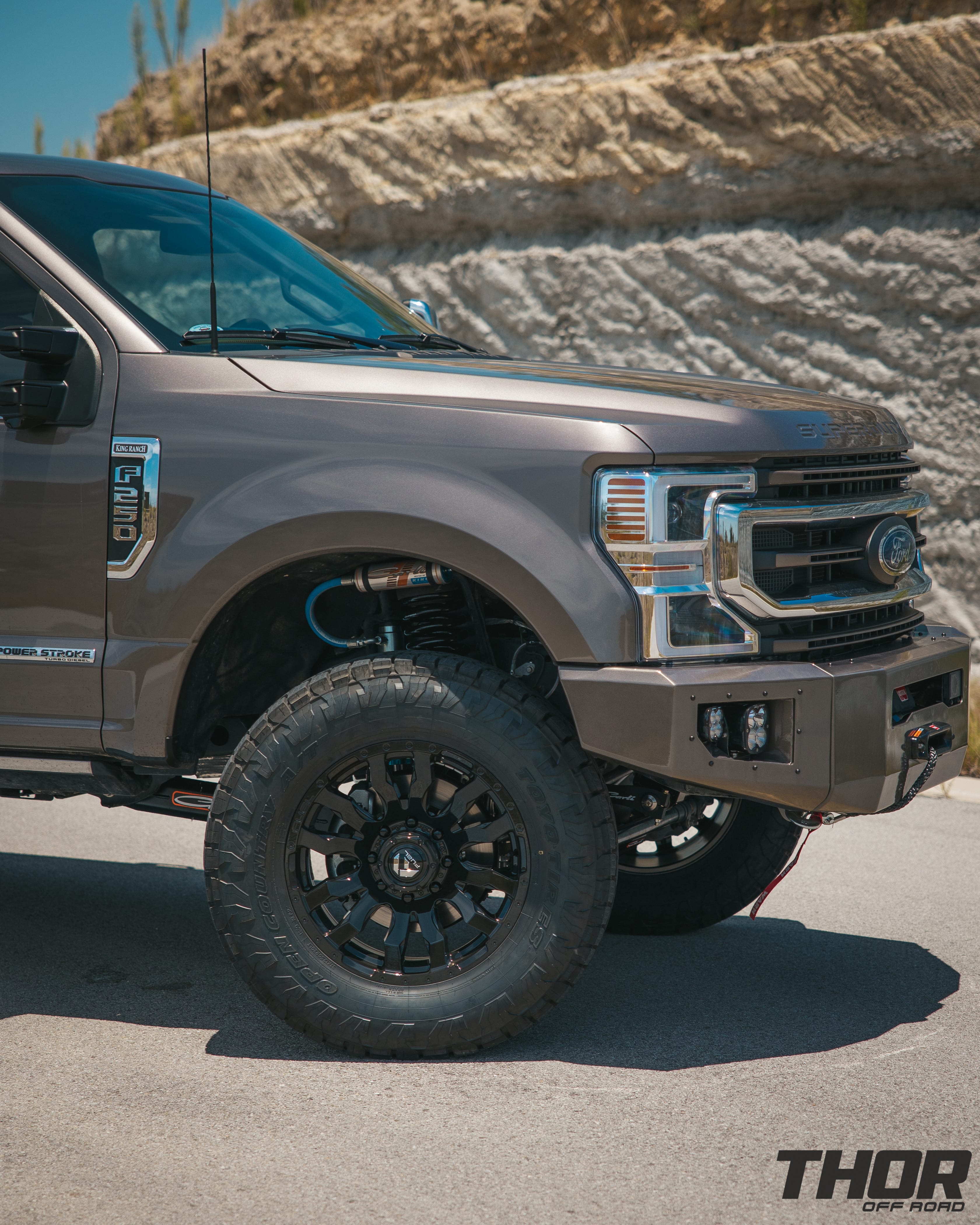 2022 Ford F-250 Super Duty King Ranch in Stone Grey with 3.5" Carli King Pintop Suspension Kit, Carli Torsion Sway Bar, Carli Fabricated Radius Arms, Carli Rear Full Leaf Springs, 20" Fuel Blitz Wheels, 37x12.50R20 Toyo ATIII Tires, CJC Front and Rear Bumpers, Baja Design XL Squadron Lighting, Warn 12S Winch