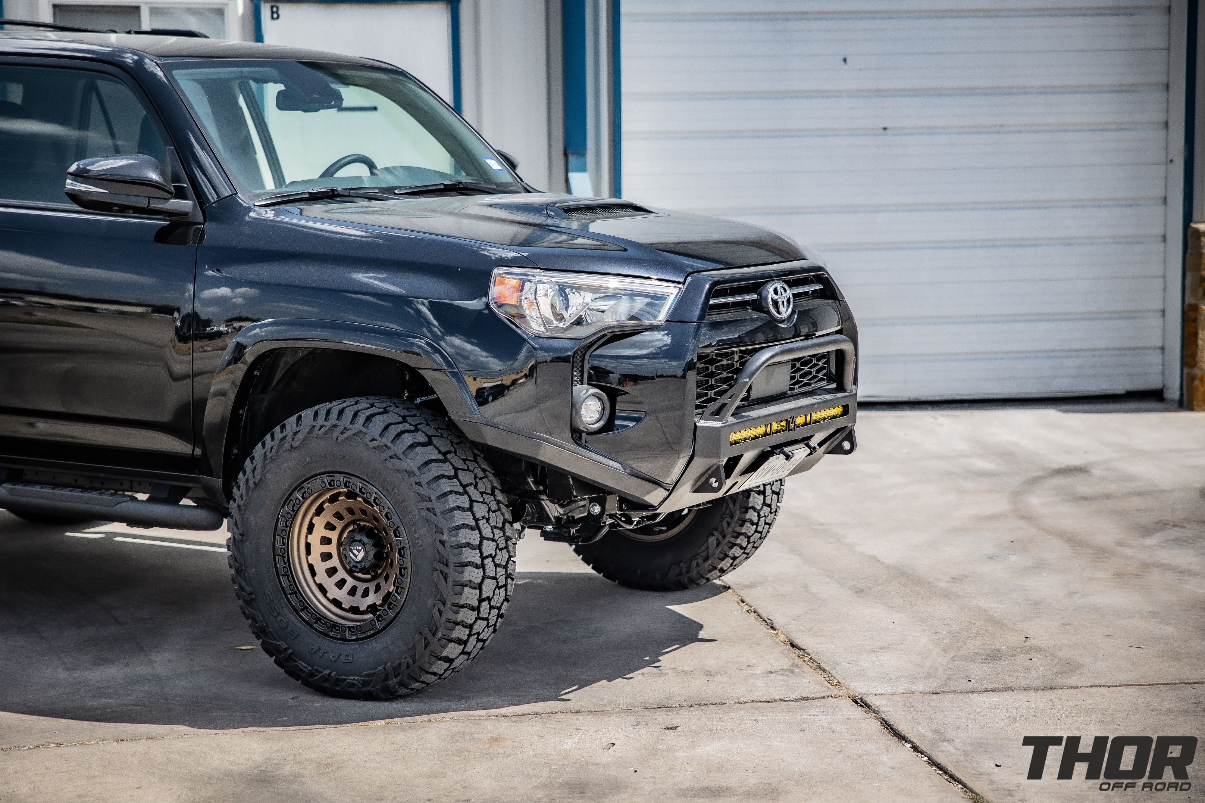 2020 Toyota 4Runner TRD Off-Road in Black with Icon 0-3.5" Stage 5 Suspension System with Tubular UCA, 17x9" Fuel Zephyr Bronze Wheels, 295/70R17 Baja Boss AT Tires, C4 Low Pro Bumper with Lighting, Borla Catback Touring Exhaust