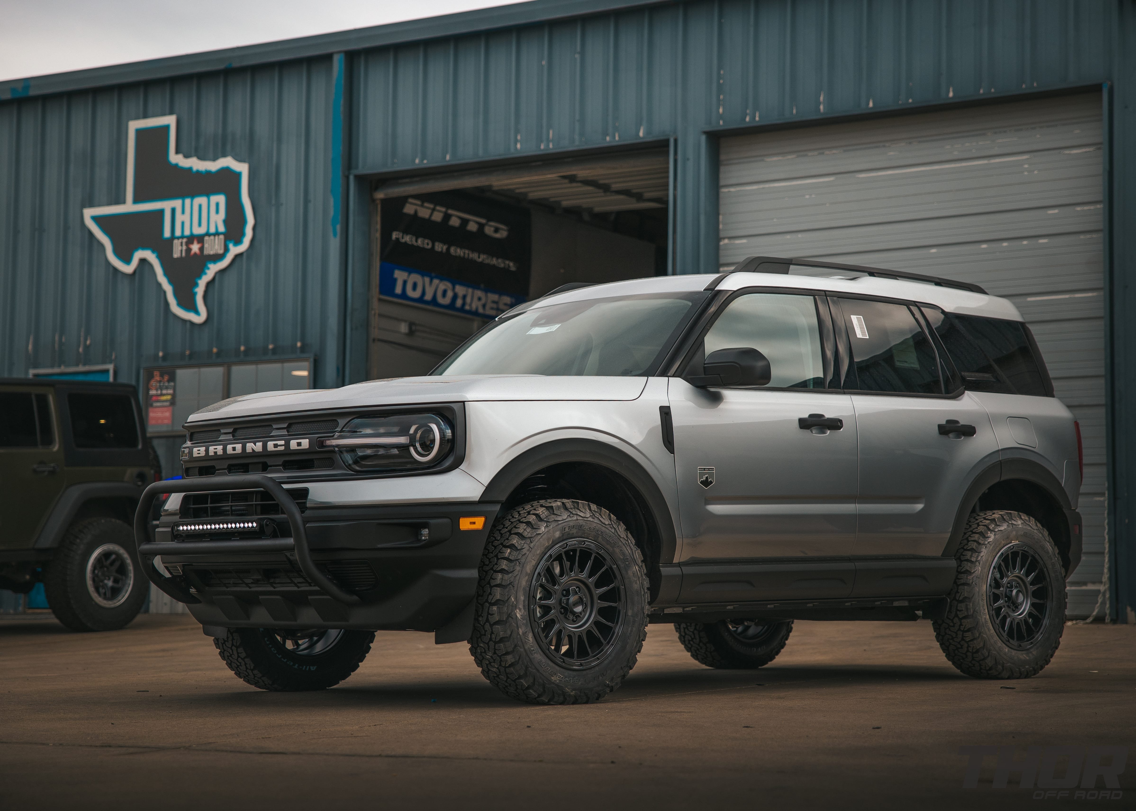 2021 Ford Bronco Big Bend in Silver with 1.5" ReadyLift Suspension Kit, 17x8" KMC Wheels, 265/45R17 BFG Tires, Rough Counttry Nudge Bar, 20" Bumper Light Bar