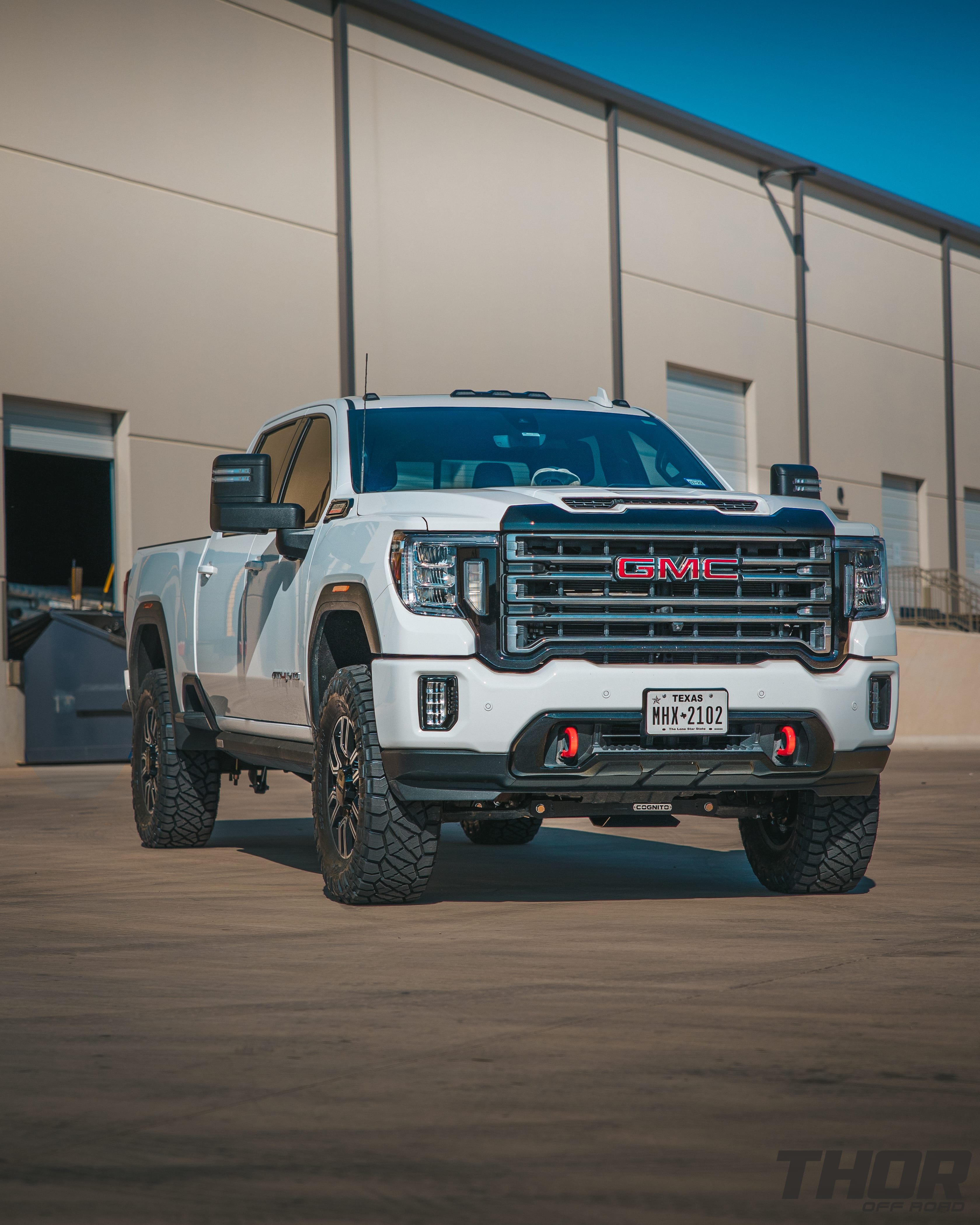 2020 GMC Sierra 2500 HD AT4 in White with 4" Cognito Suspension Kit with FOX Reservoirs, Amp Research Power Steps, 37x12.50R20 Nitto Ridge Grappler Tires