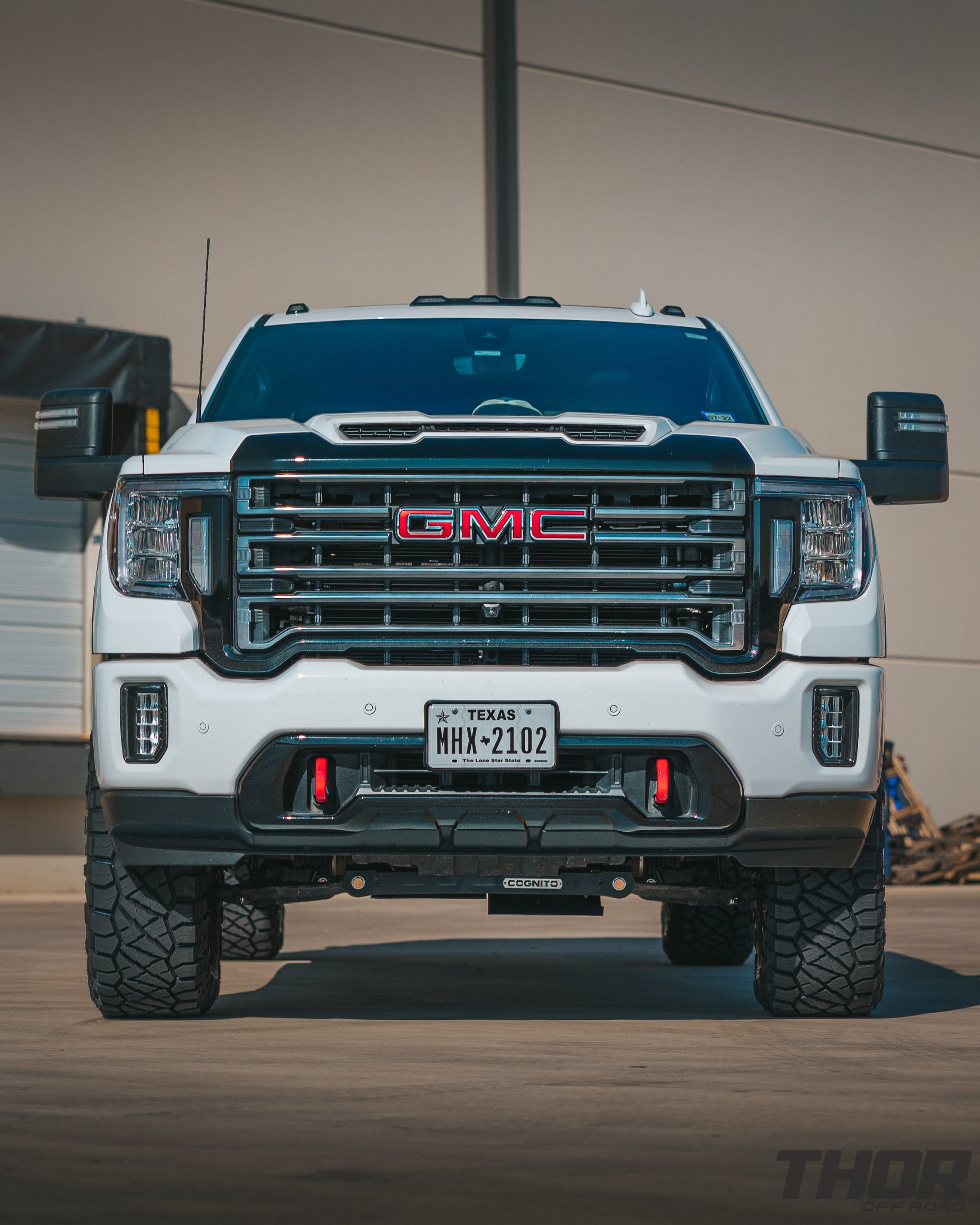 2020 GMC Sierra 2500 HD AT4 in White with 4" Cognito Suspension Kit with FOX Reservoirs, Amp Research Power Steps, 37x12.50R20 Nitto Ridge Grappler Tires