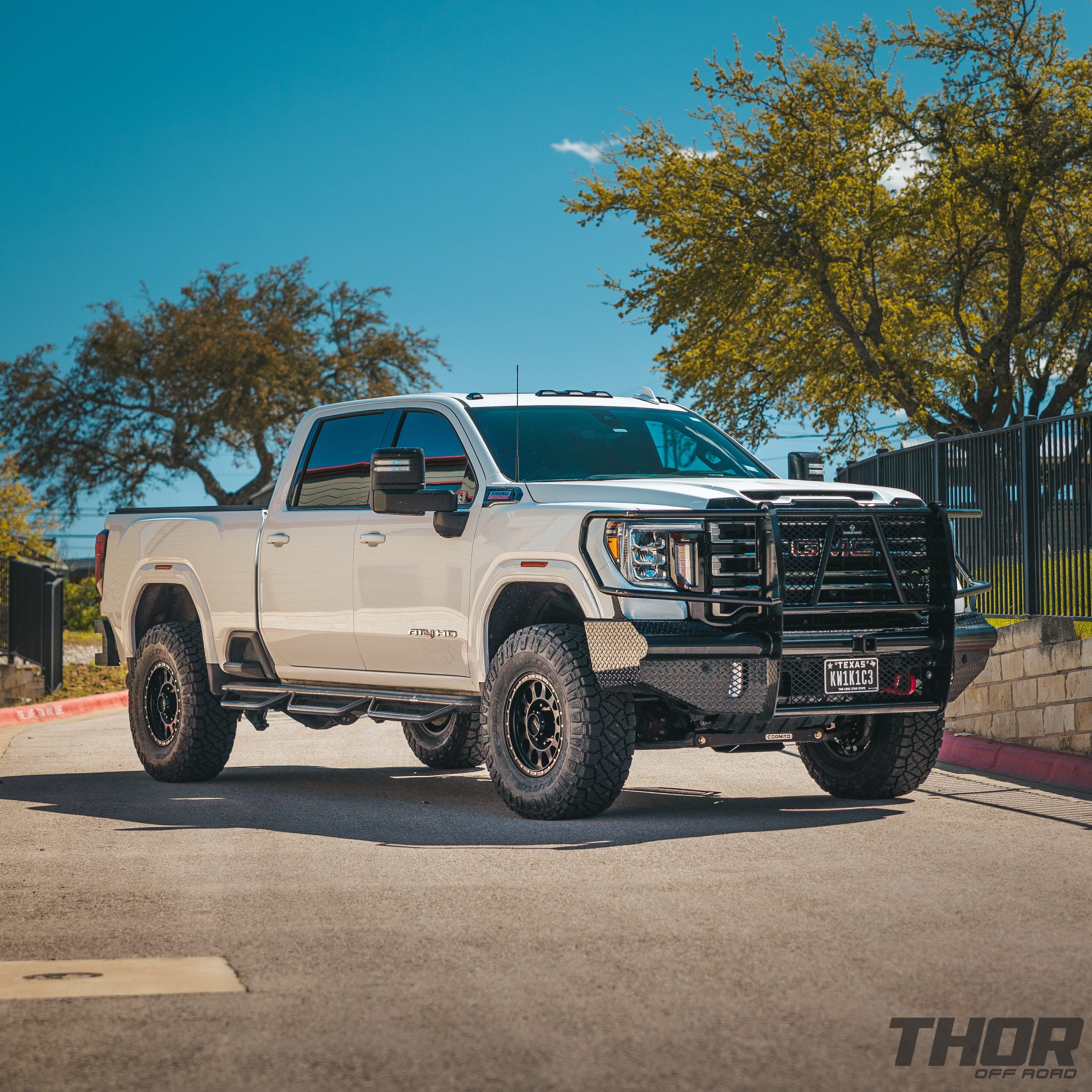 2022 GMC Sierra 2500 HD AT4 in White with 4" Cognito Performance Suspension Kit, 18" Method MR315 Wheels, 37x12.50R18 Nitto Ridge Grappler Tires, Ranch Hand Legend Front Bumper, Ranch Hand Legend Rear Bumper, Ranch Hand Wheel to Wheel Steps