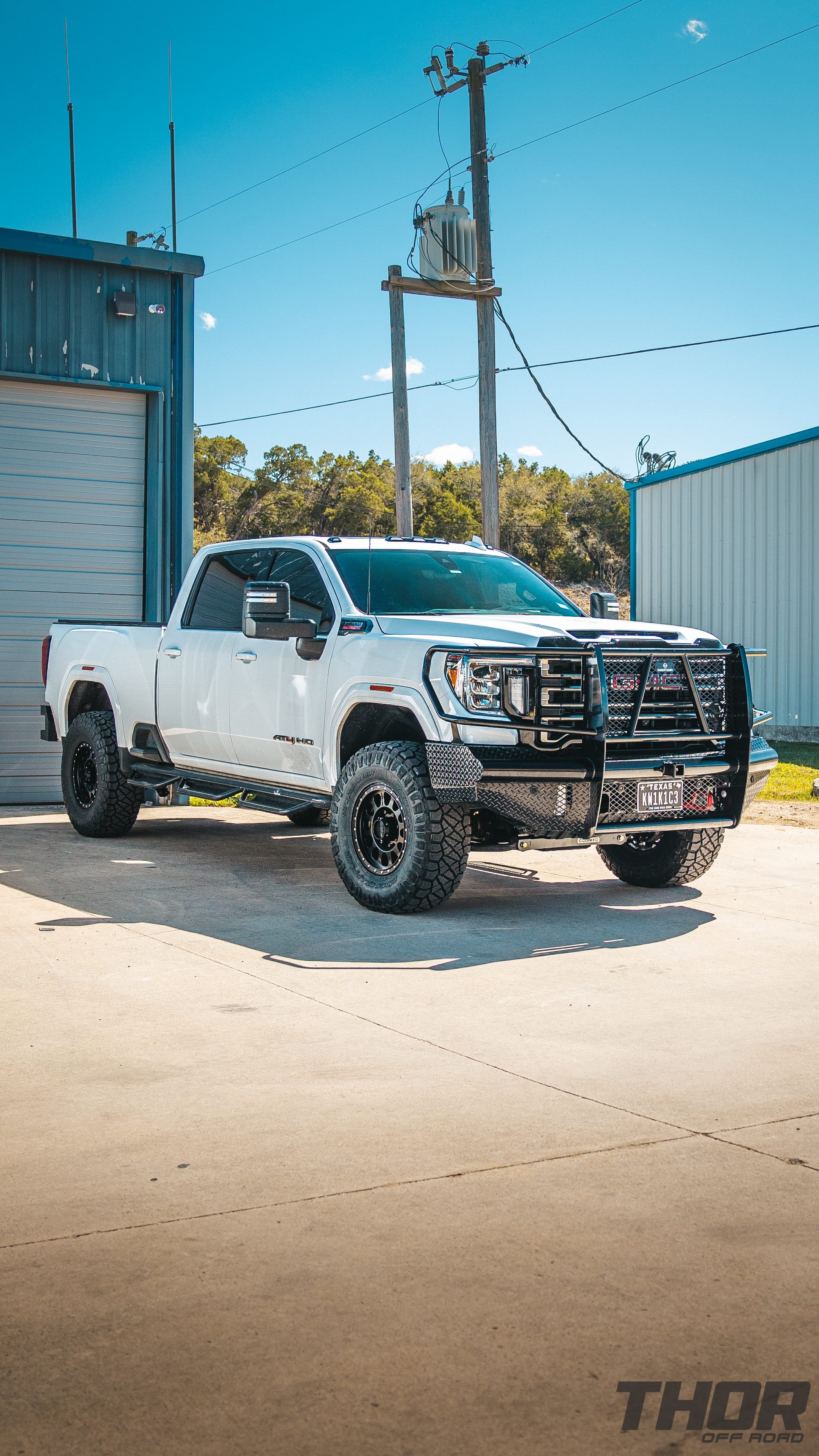2022 GMC Sierra 2500 HD AT4 in White with 4" Cognito Performance Suspension Kit, 18" Method MR315 Wheels, 37x12.50R18 Nitto Ridge Grappler Tires, Ranch Hand Legend Front Bumper, Ranch Hand Legend Rear Bumper, Ranch Hand Wheel to Wheel Steps
